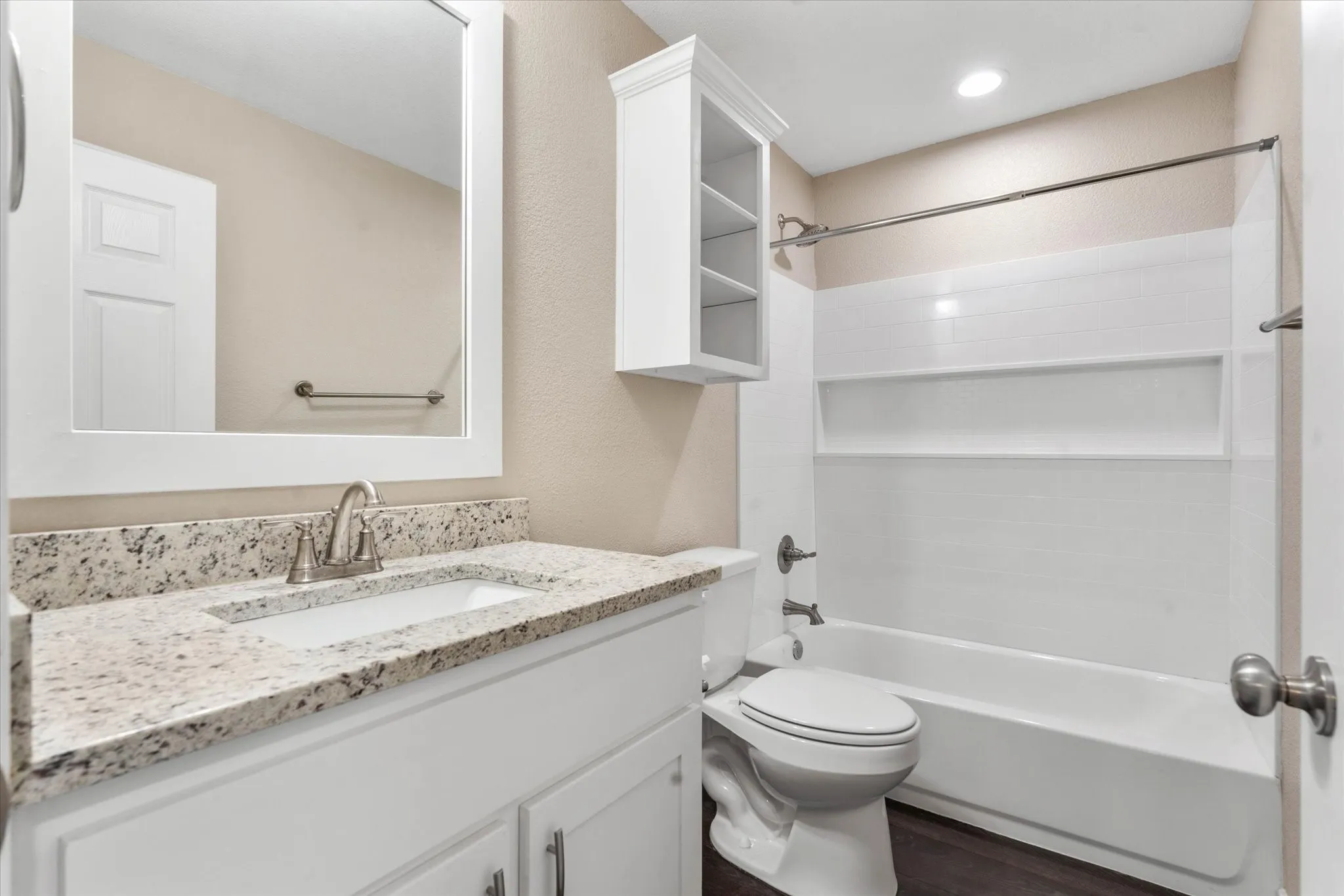 Full bathroom with vanity, toilet, wood-type flooring, and shower / tub combination