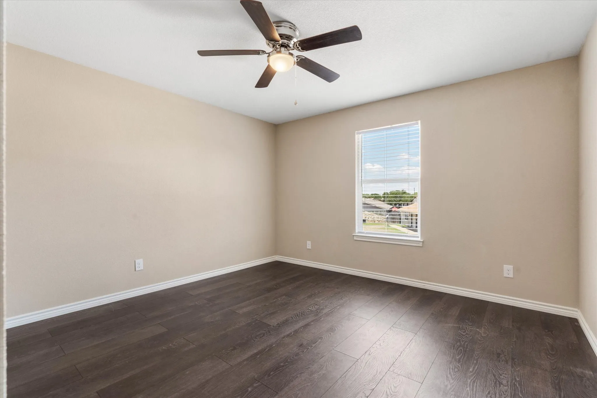 Spare room with ceiling fan and hardwood / wood-style flooring