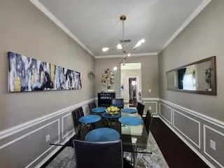 Crown molding and wainscoting detailing enhance this room