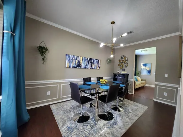 Wood-finish flooring, crown molding, and wainscoting detailing