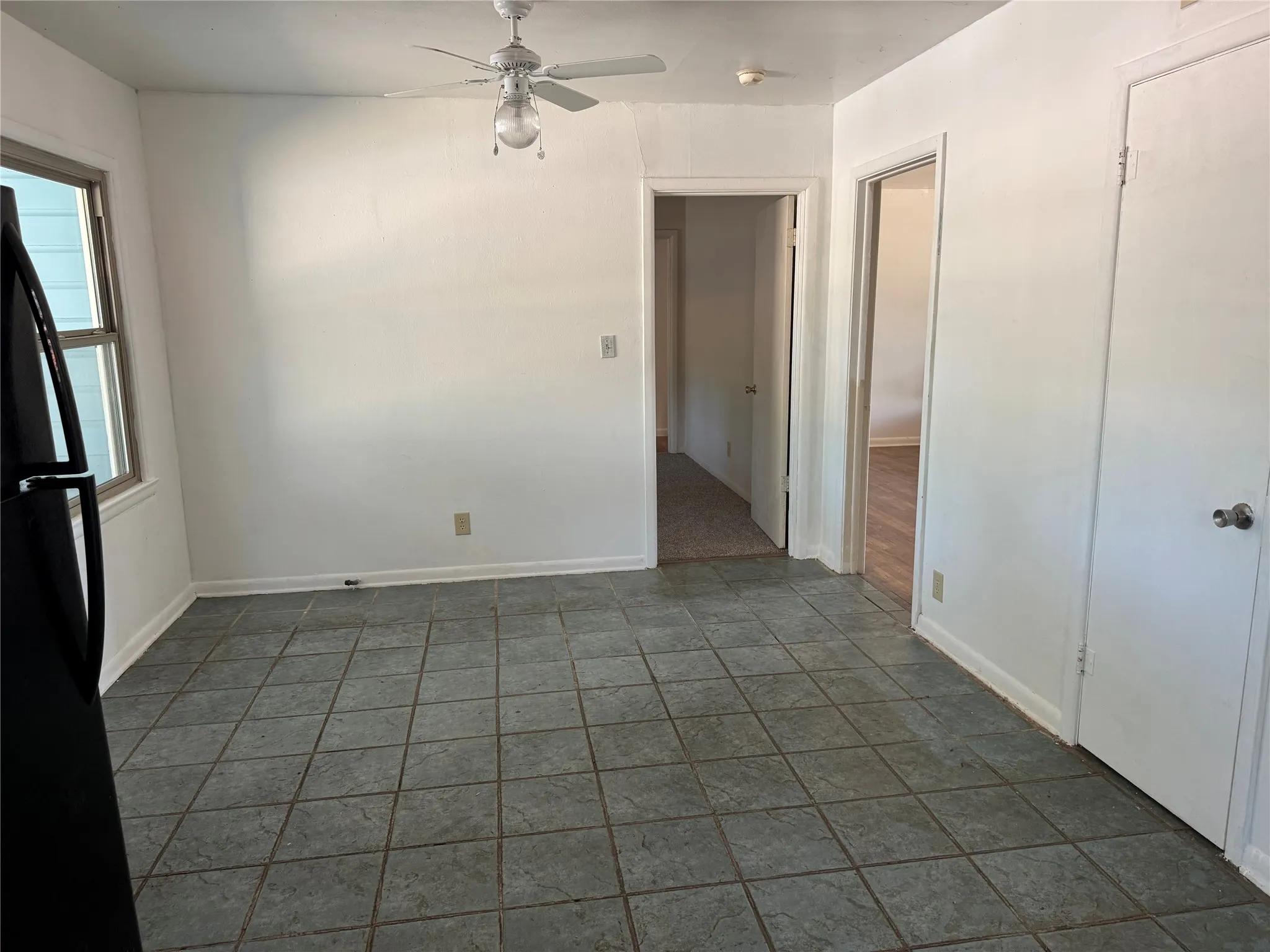 Tiled open kitchen and dining area. Dining area view from kitchen.