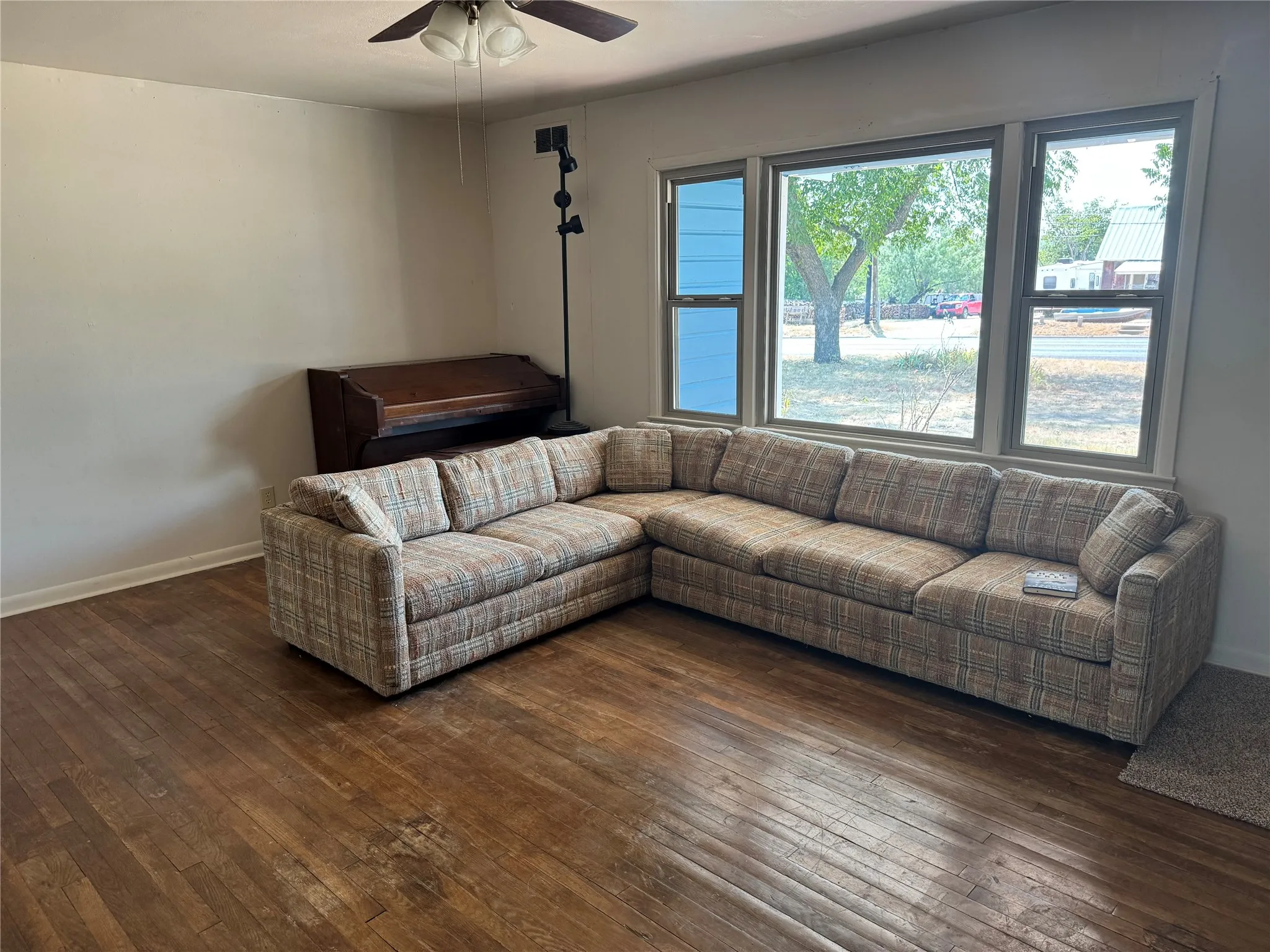 Spacious living area with wood floors and lots of natural light.