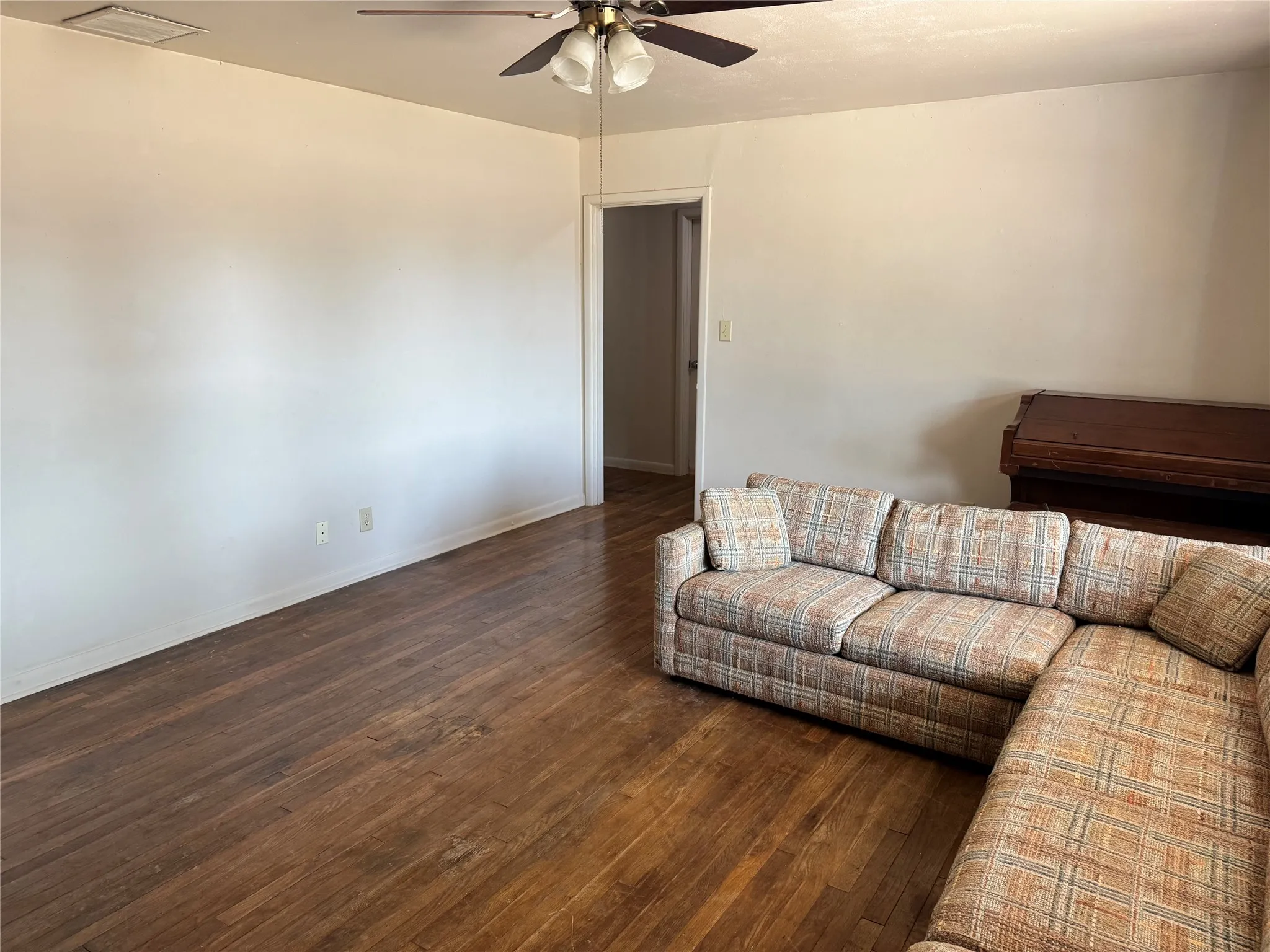Spacious living area with wood floors and lots of natural light.