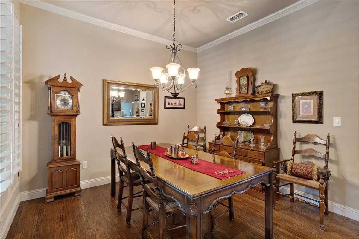 Hardwood flooring, crown molding, and neutral wall tones