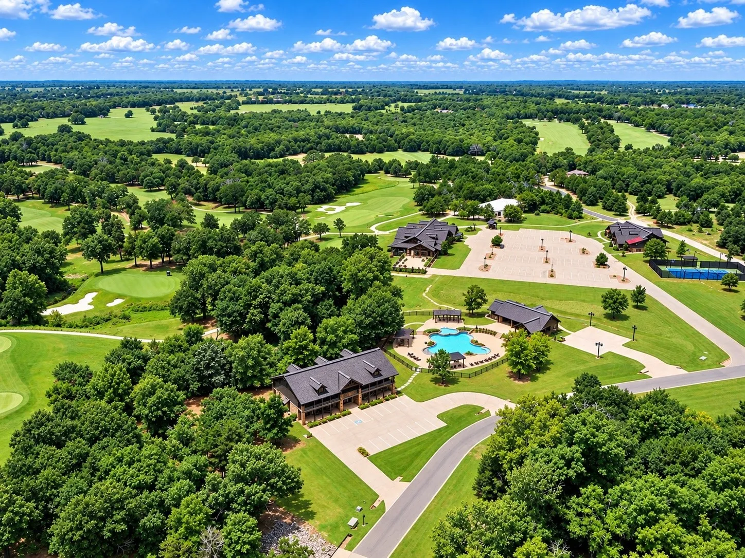 Expansive golf course, community pool, multiple recreational buildings, tennis courts, and paved parking areas
