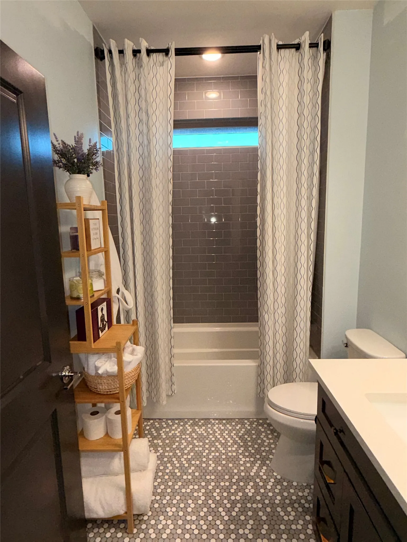 Beautiful Penny tile floors. Combined shower and bath has ceiling height tile.