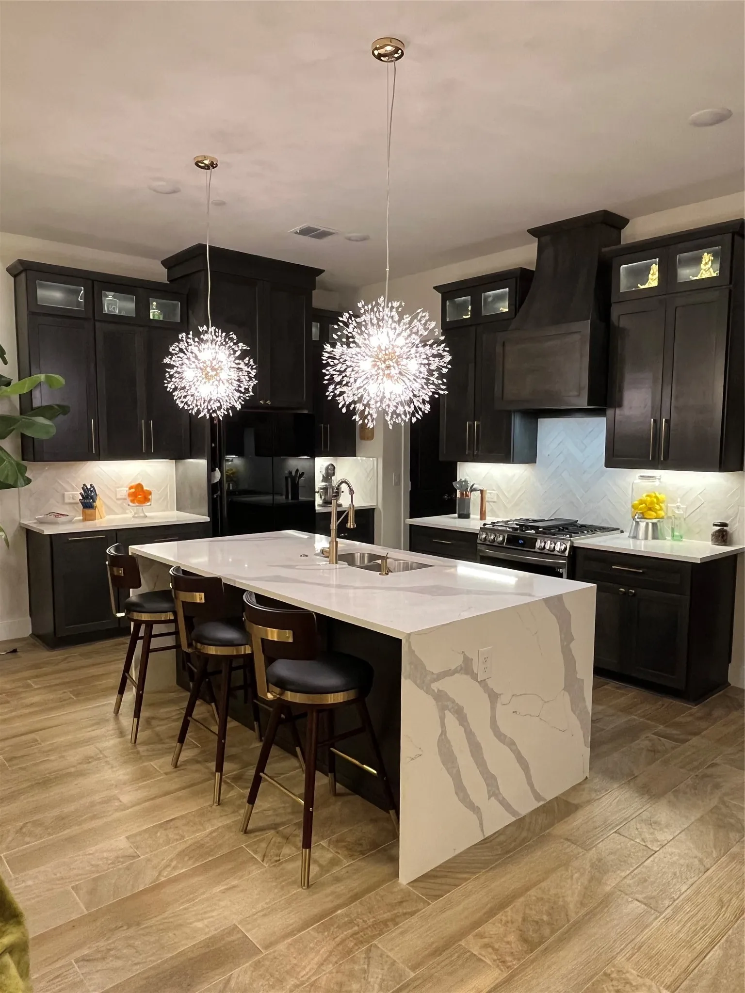 Beautiful gold pendant with quartz countertop waterfall edge Island