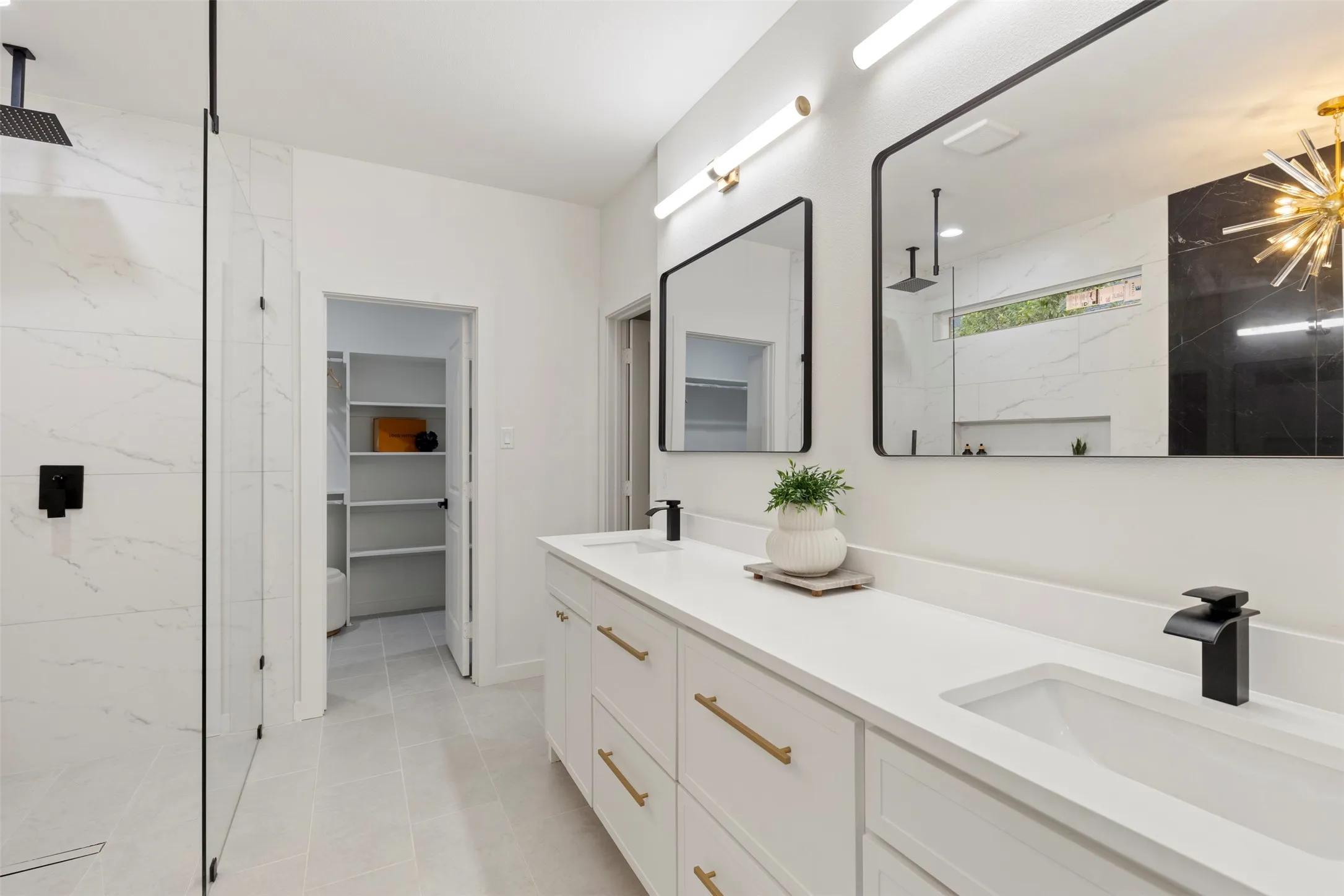 Dual vanity with white countertops, undermount sinks, and matte black faucets