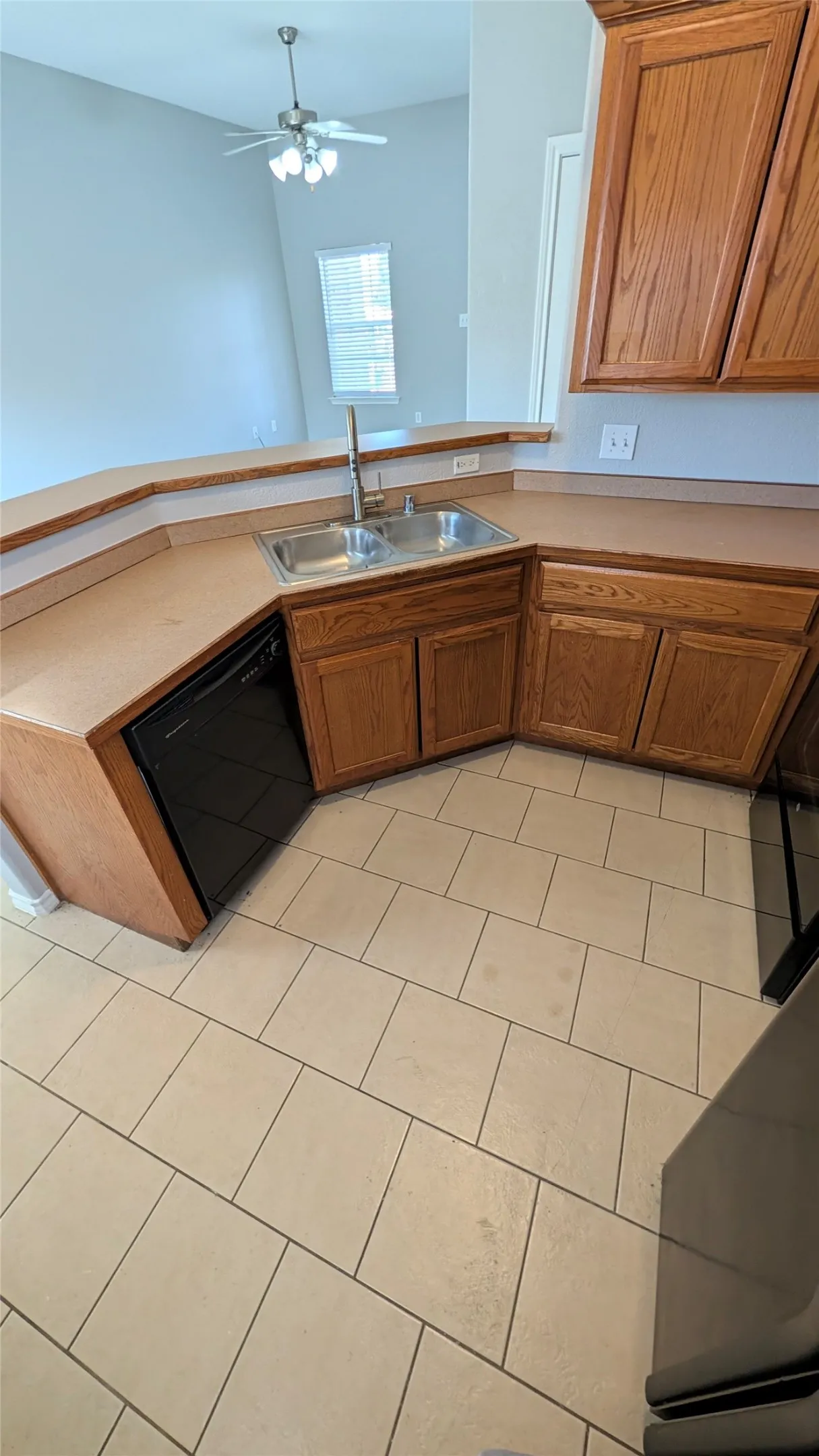 Long breakfast bar can seat 4 comfortably. Kitchen opens to living and dining area.
