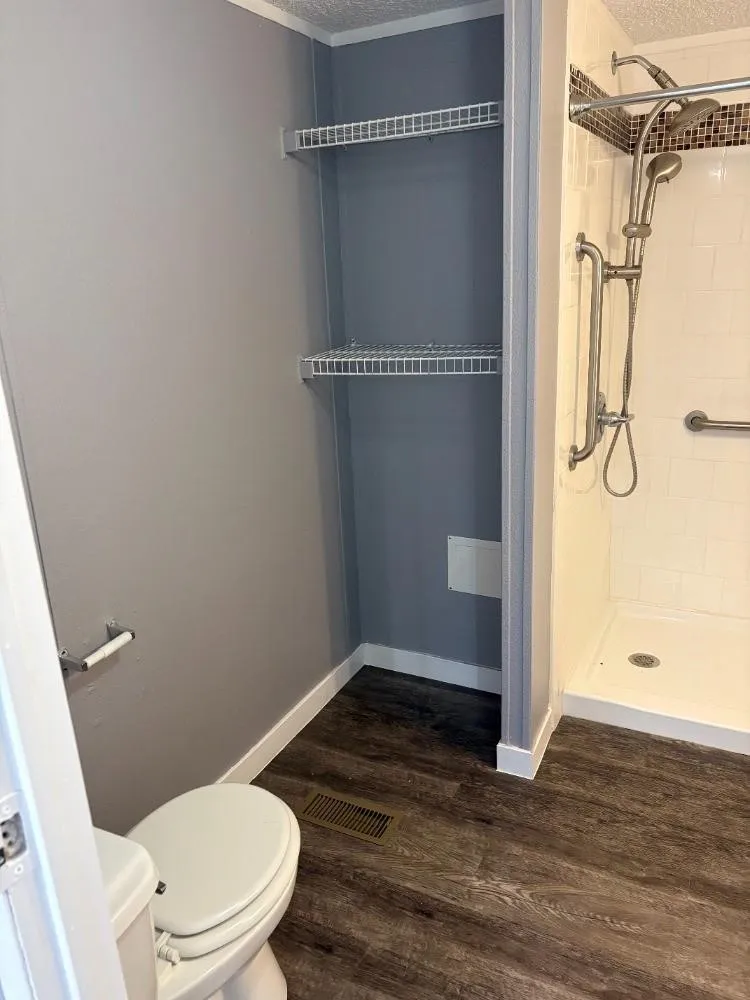 Walk-in shower with white subway tile, mosaic accent, and dual shower heads