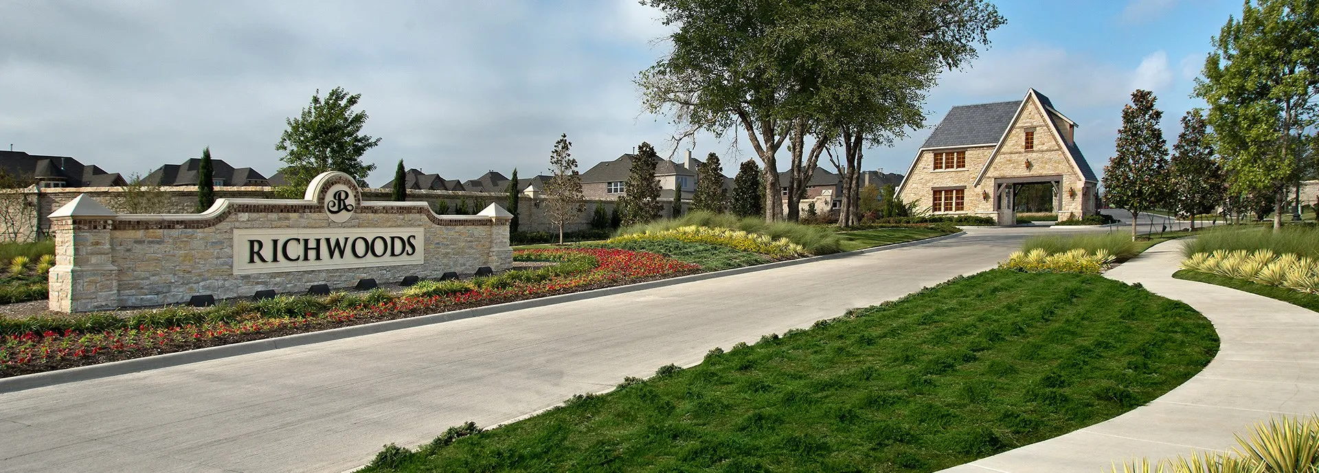 Stone entry monument with established landscaping