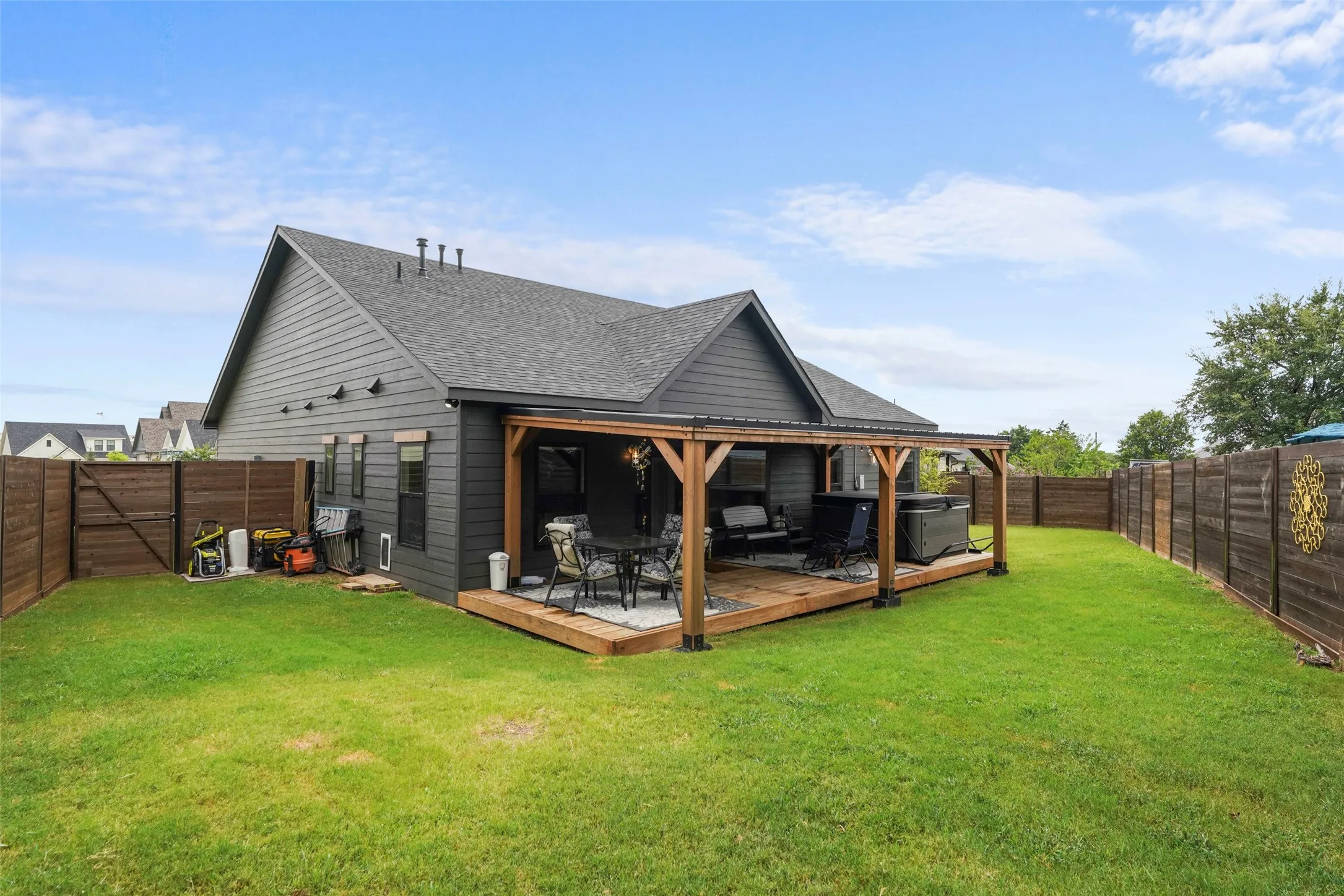 Expansive grass lawn with a wood-fenced perimeter