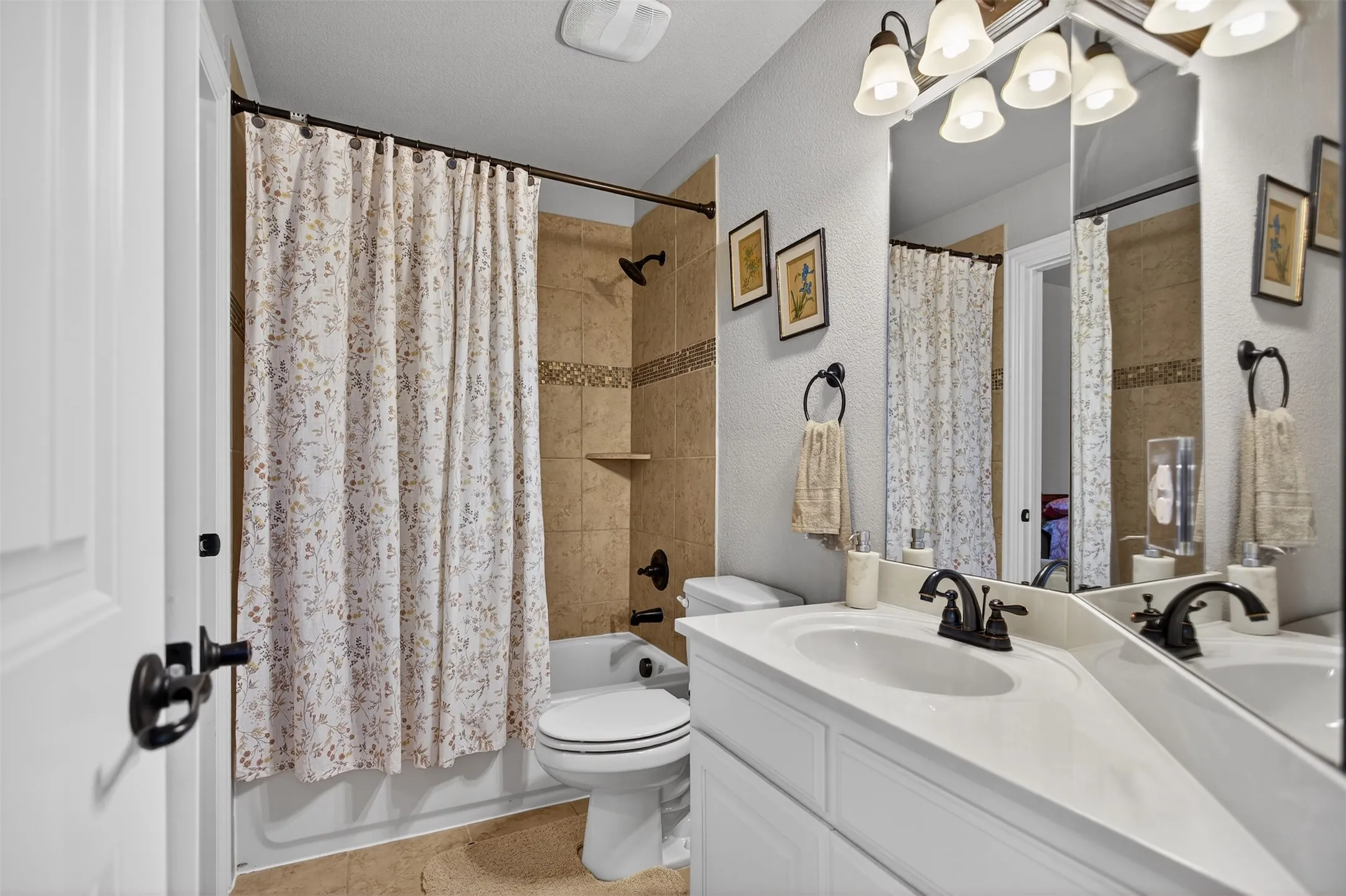 Built-in vanity with integrated sink, bronze-finish faucet, and coordinating mirror