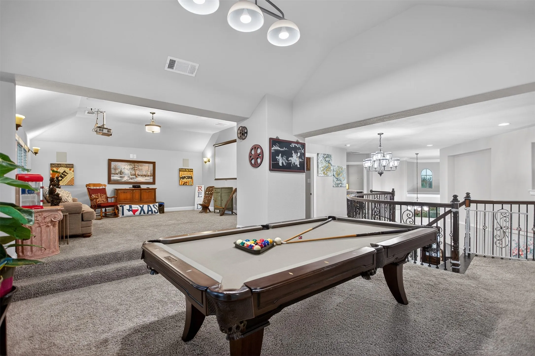 Spacious bonus room featuring vaulted ceilings, recessed lighting, and a built-in projector