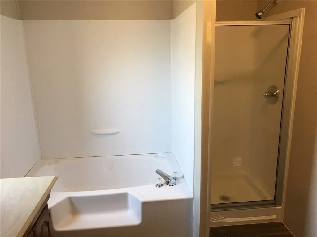 Integrated shower-over-tub combination with white acrylic surround
