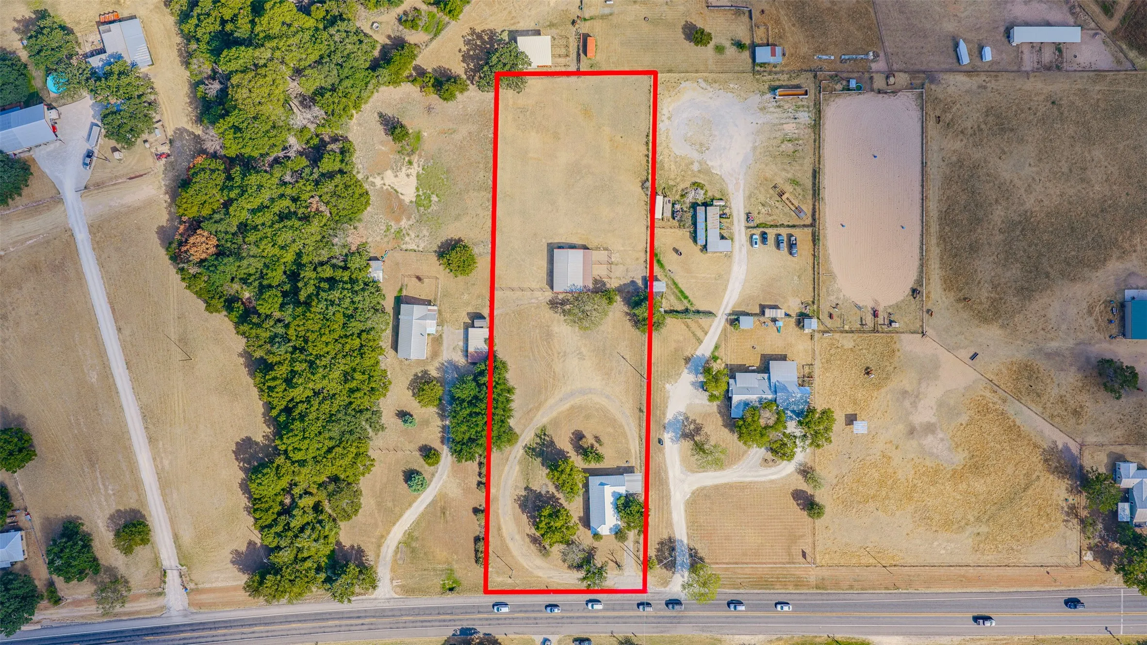 Expansive property featuring an elongated lot, two distinct structures, and a dedicated driveway system