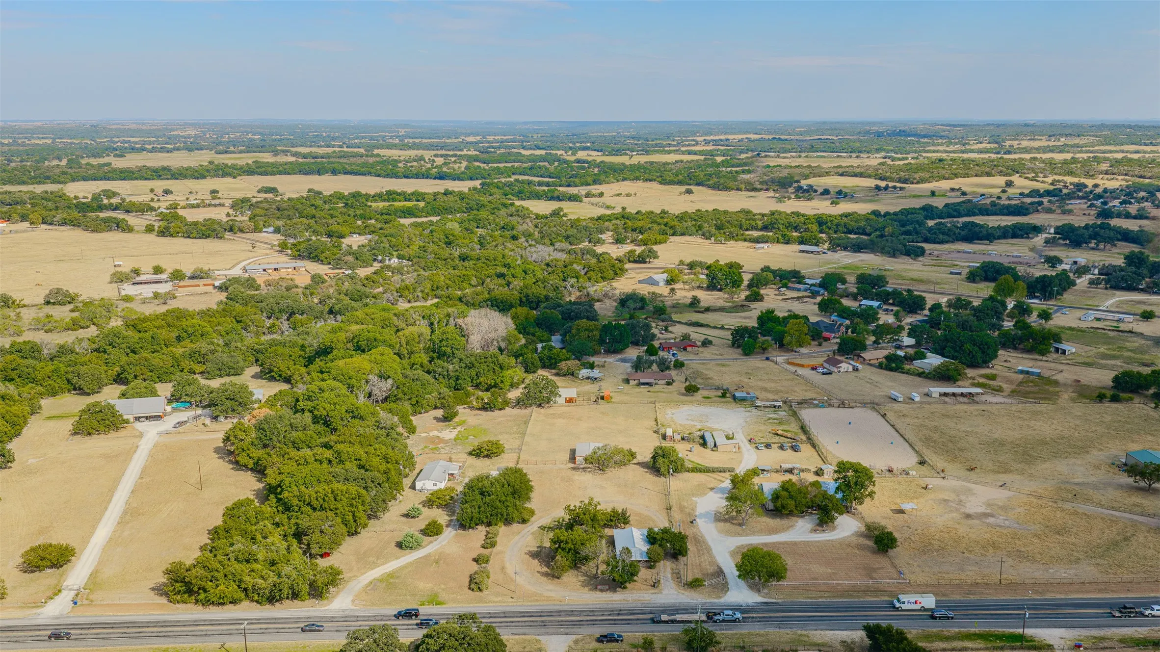 Expansive rural landscape featuring scattered trees and open fields