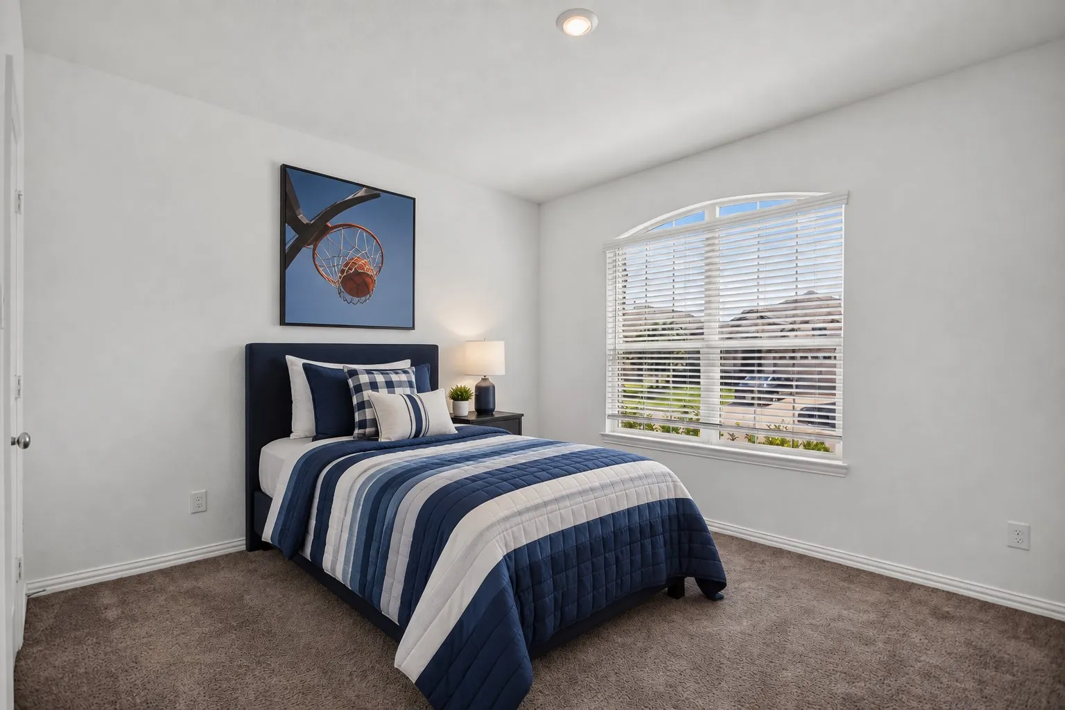 Arched window with blinds, recessed ceiling lighting, and wall-to-wall carpeting