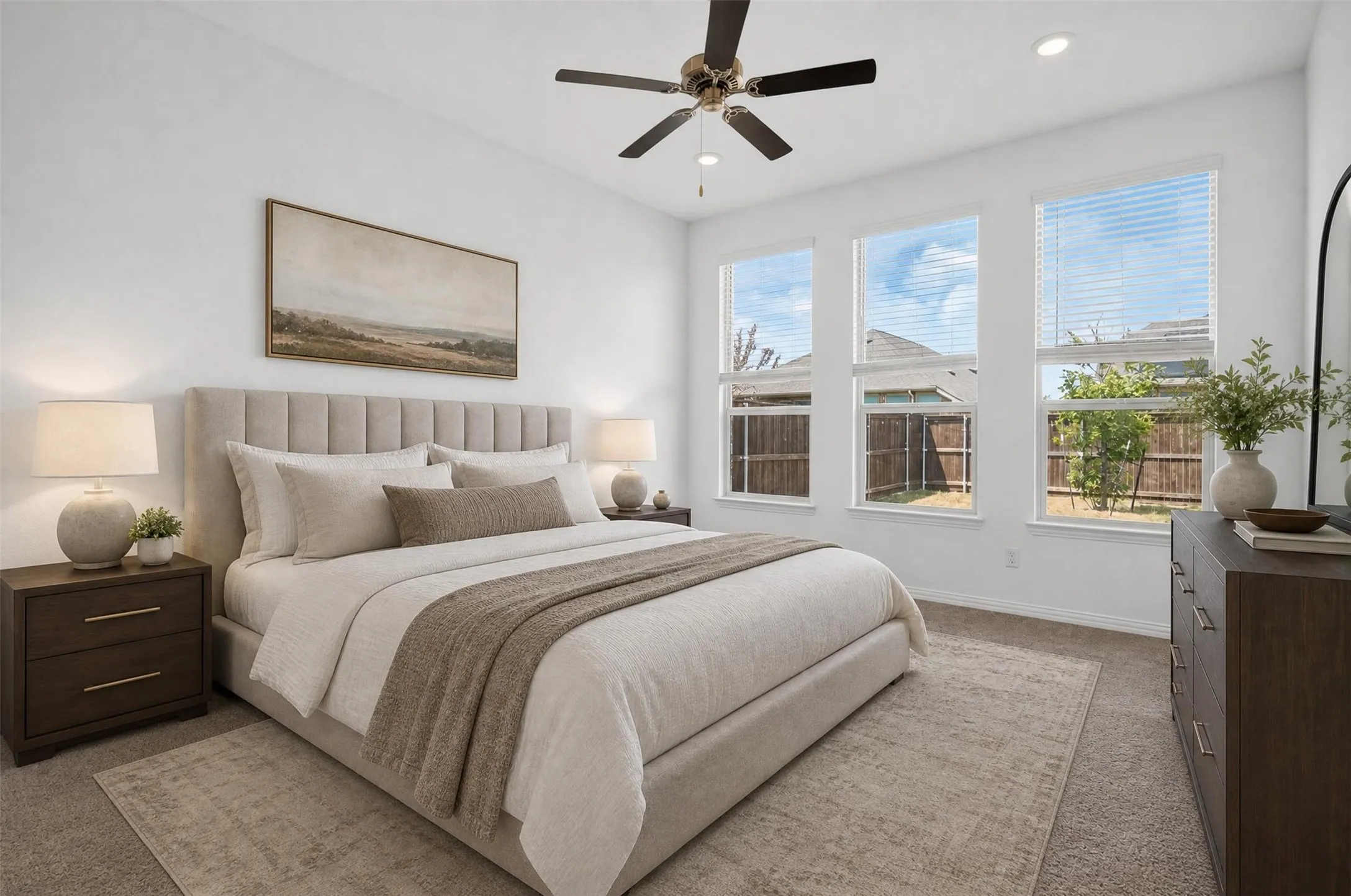 Recessed lighting, ceiling fan, three vertical windows, carpeted flooring, and a dark wood-finish dresser