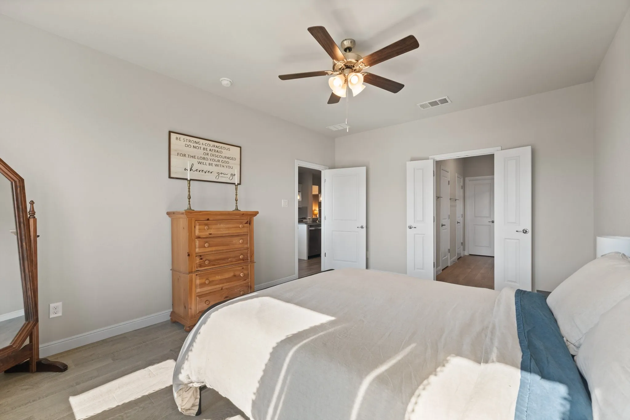 Recessed lighting, wood-finish flooring, and a ceiling fan with integrated lighting