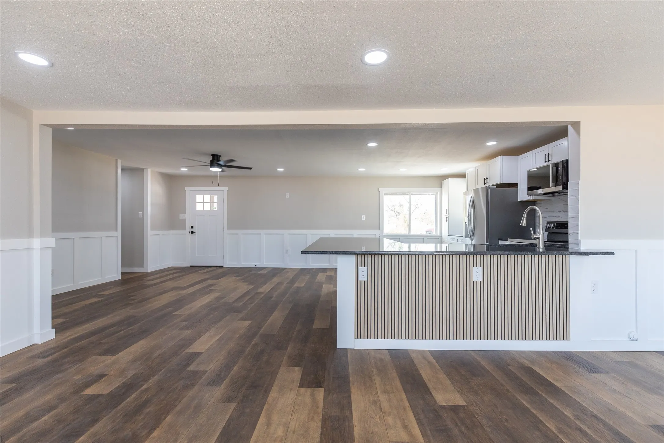 Front door into first living space and kitchen.  View from the back living space,