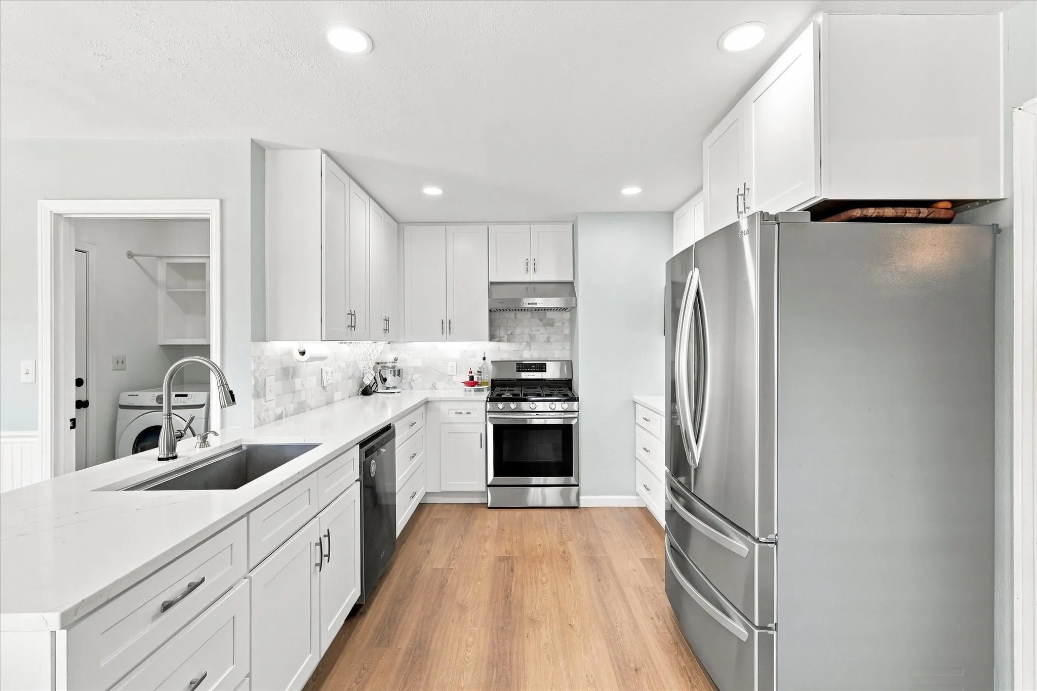 Updated kitchen with quartz counters & can lighting.