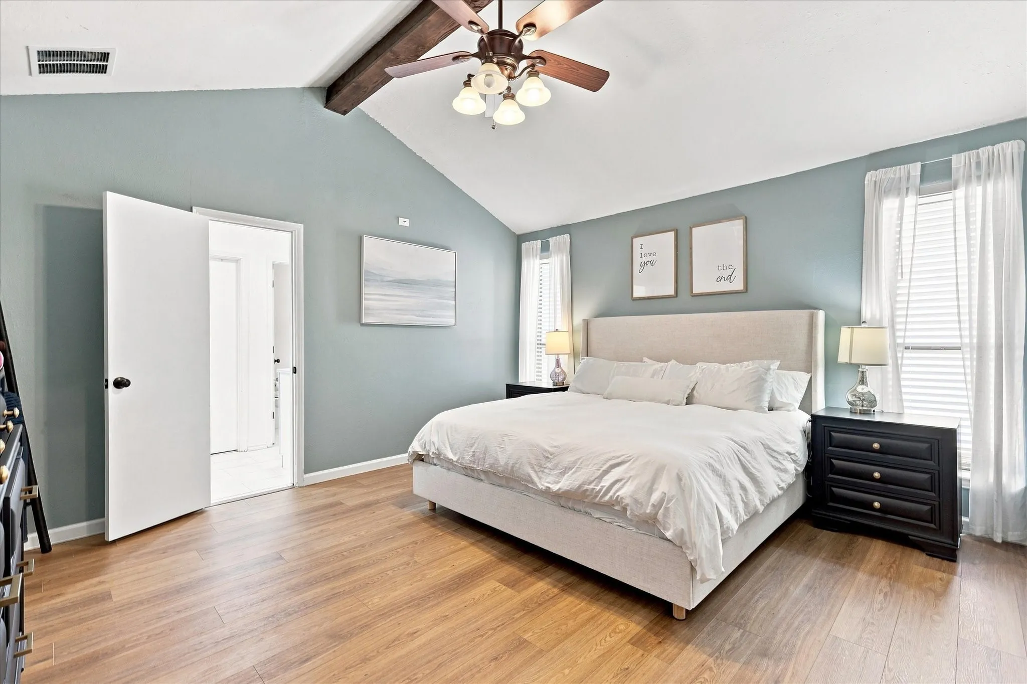 Primary bedroom with ceiling beam for accent.