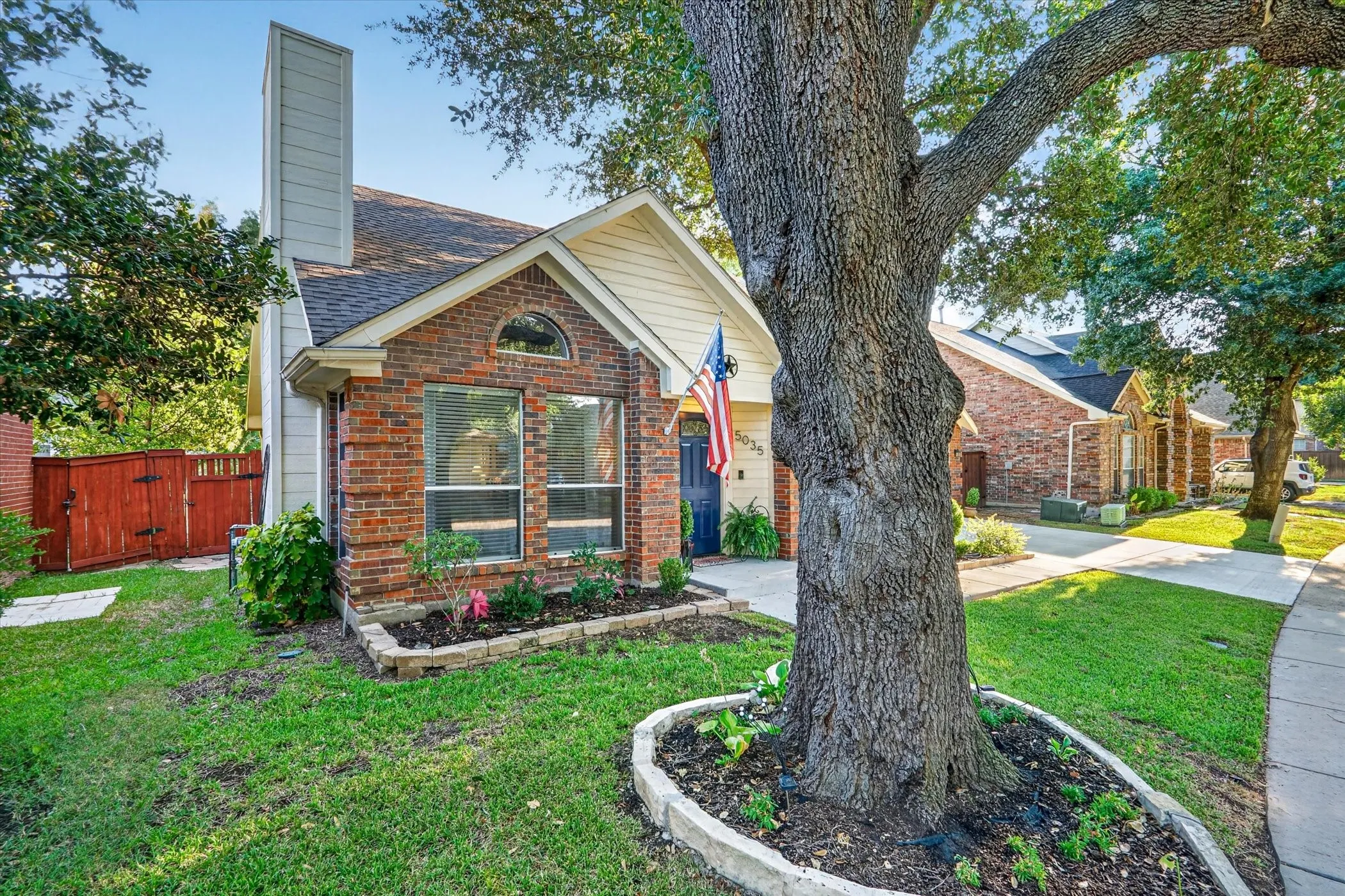 Brick exterior with white siding accents and an arched window detail