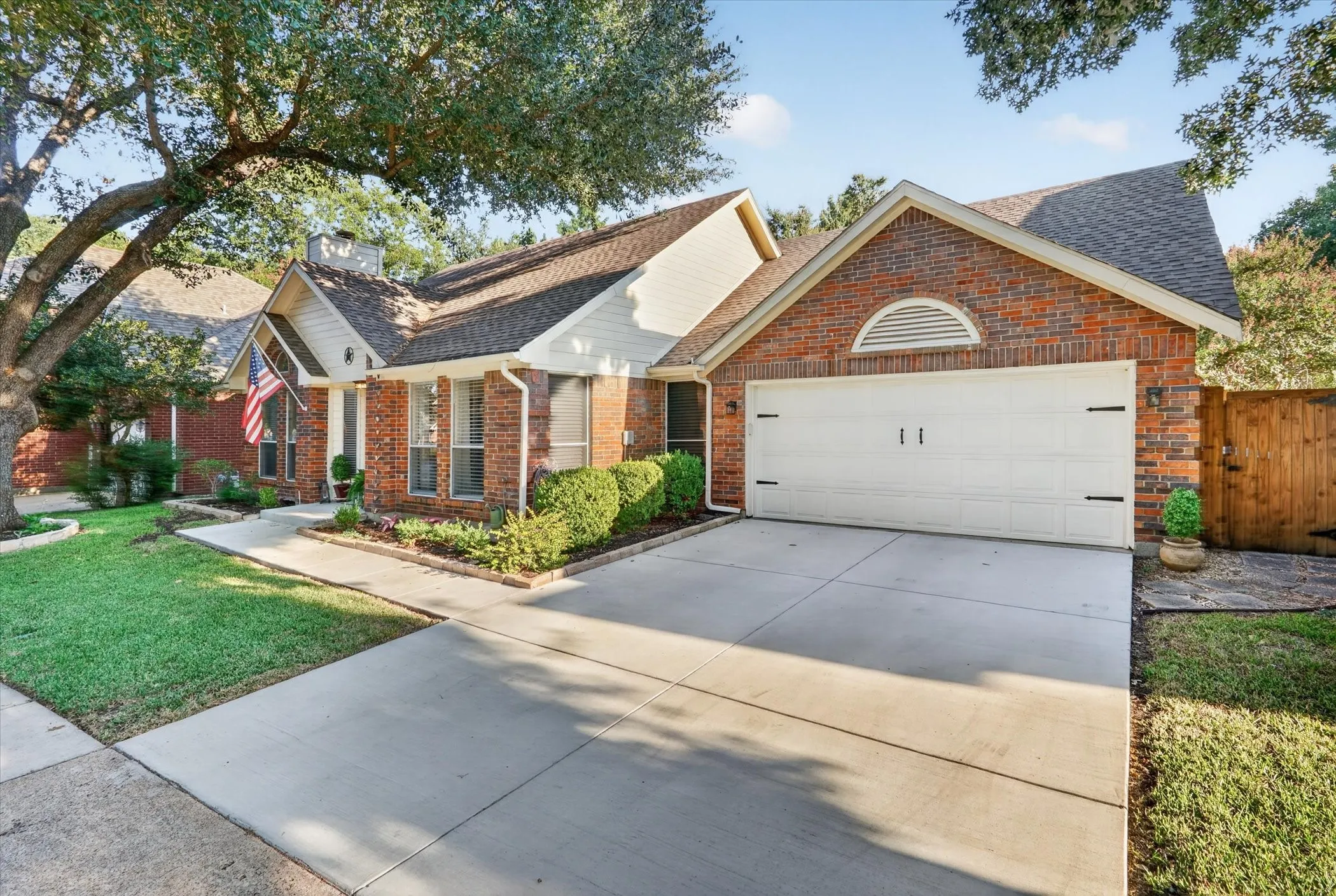 Brick exterior with a gabled roof and attached two-car garage