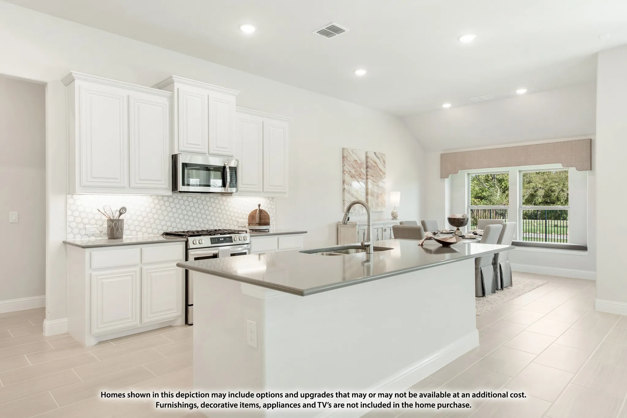 Kitchen featuring white cabinetry, a tiled backsplash, stainless steel appliances, a center island with an undermount sink, and light-toned tile flooring