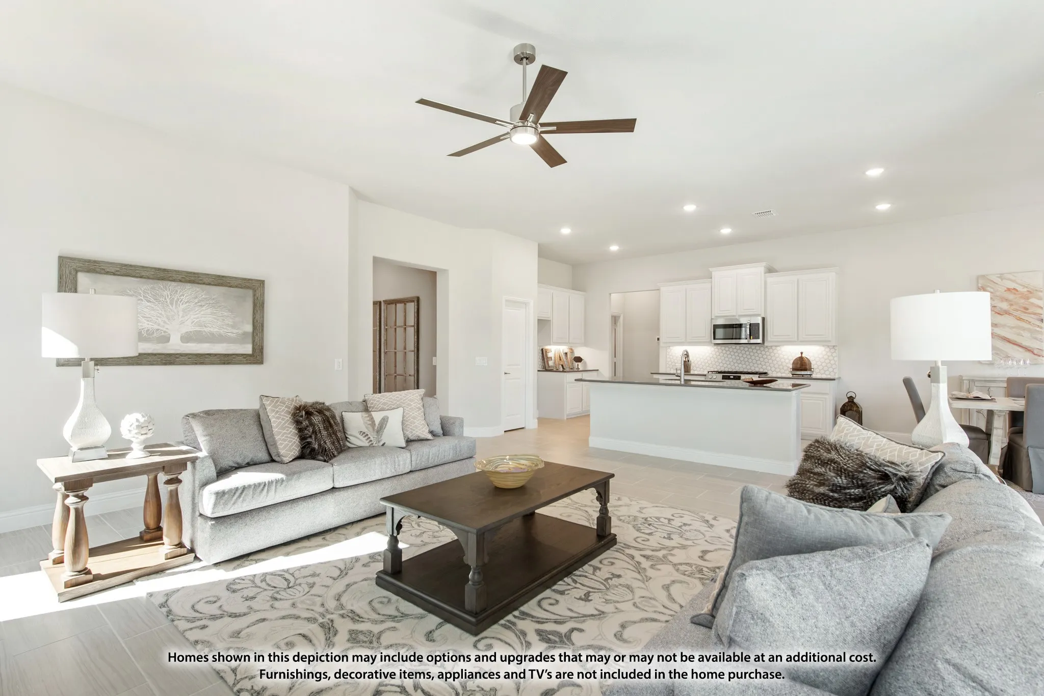 Open-concept living area featuring light-toned flooring, recessed lighting, and a ceiling fan