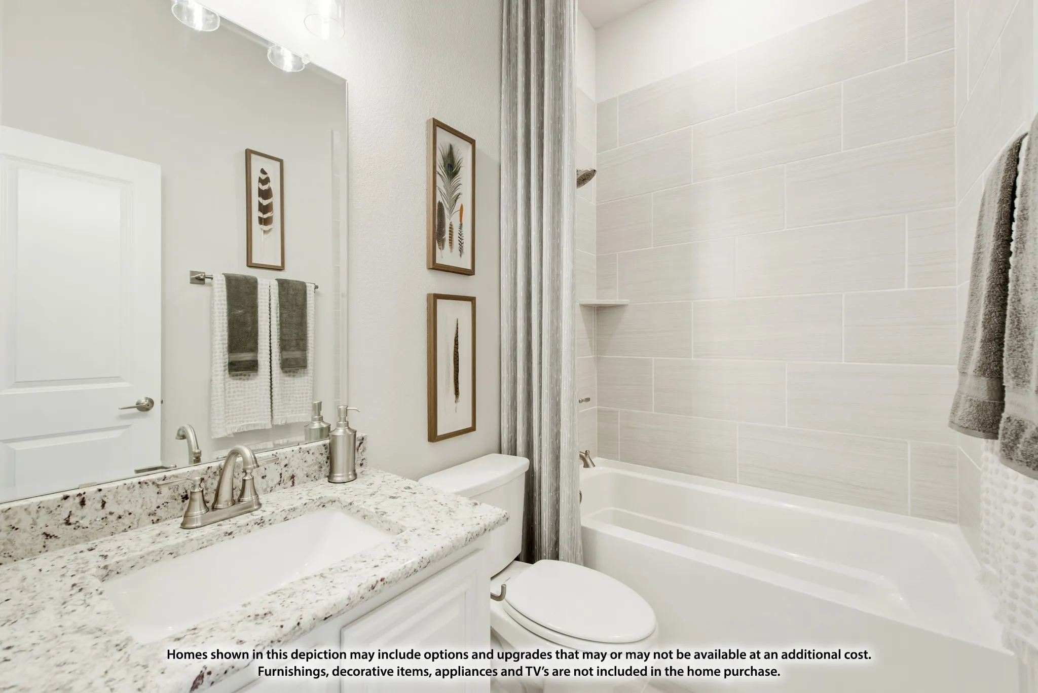 Spacious bathroom featuring a single vanity with stone-finish countertop, undermount sink, a large mirror, and a full-size bathtub with tiled surround