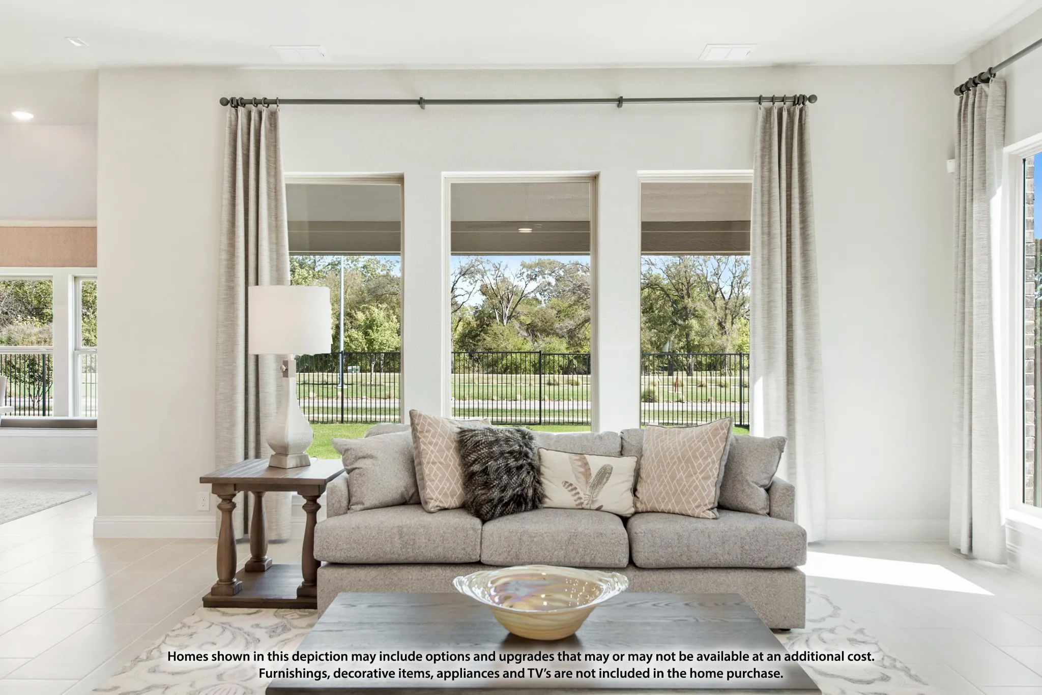 Expansive windows offering abundant natural light, high ceilings, recessed lighting, and light-toned flooring