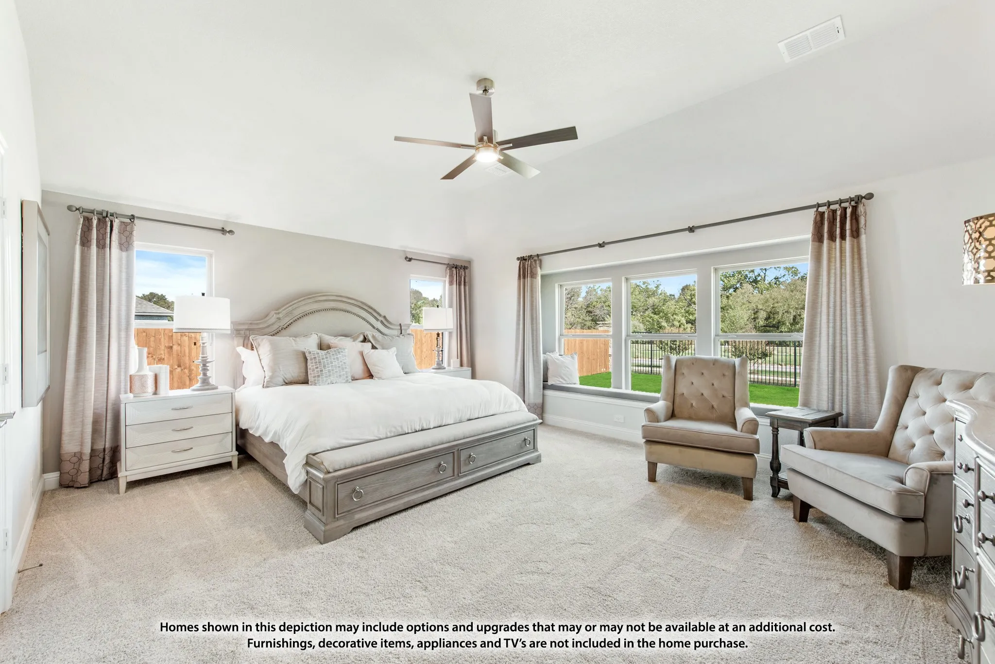Tray ceiling, ceiling fan, carpet flooring, window seat, and multiple large windows