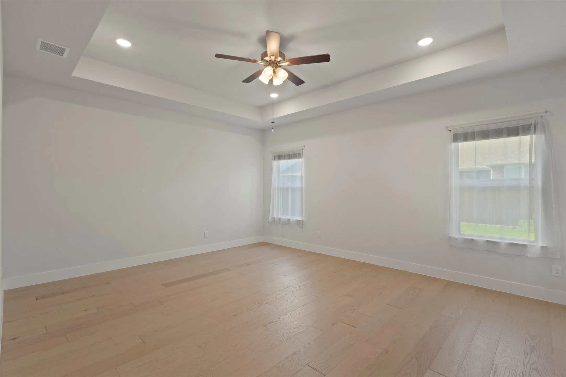 Primary Bedroom - tray ceiling and ceiling fan