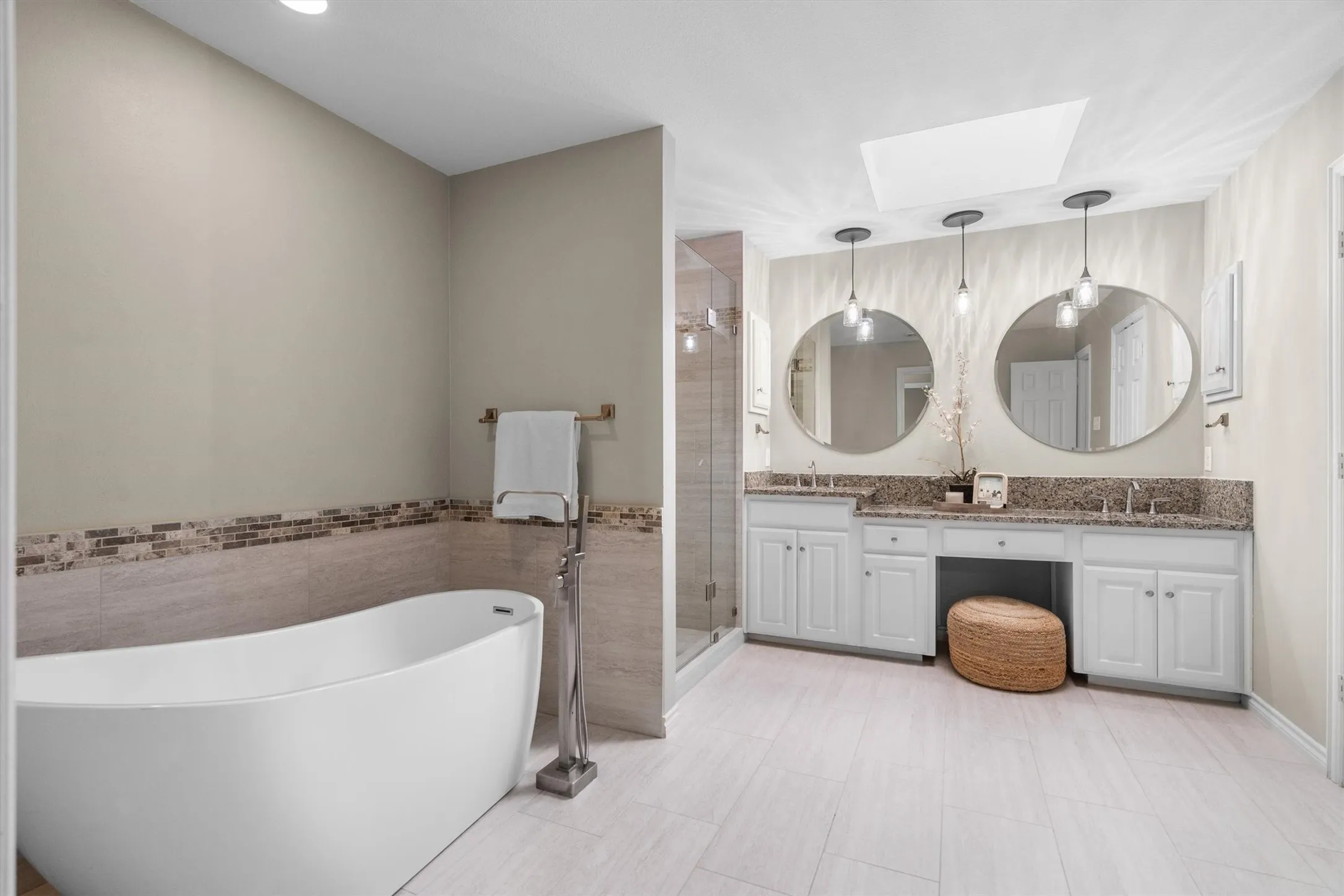 Remodled primary bath with standing tub, walk-in shower, and dual vanities.  All baths have been remodled.