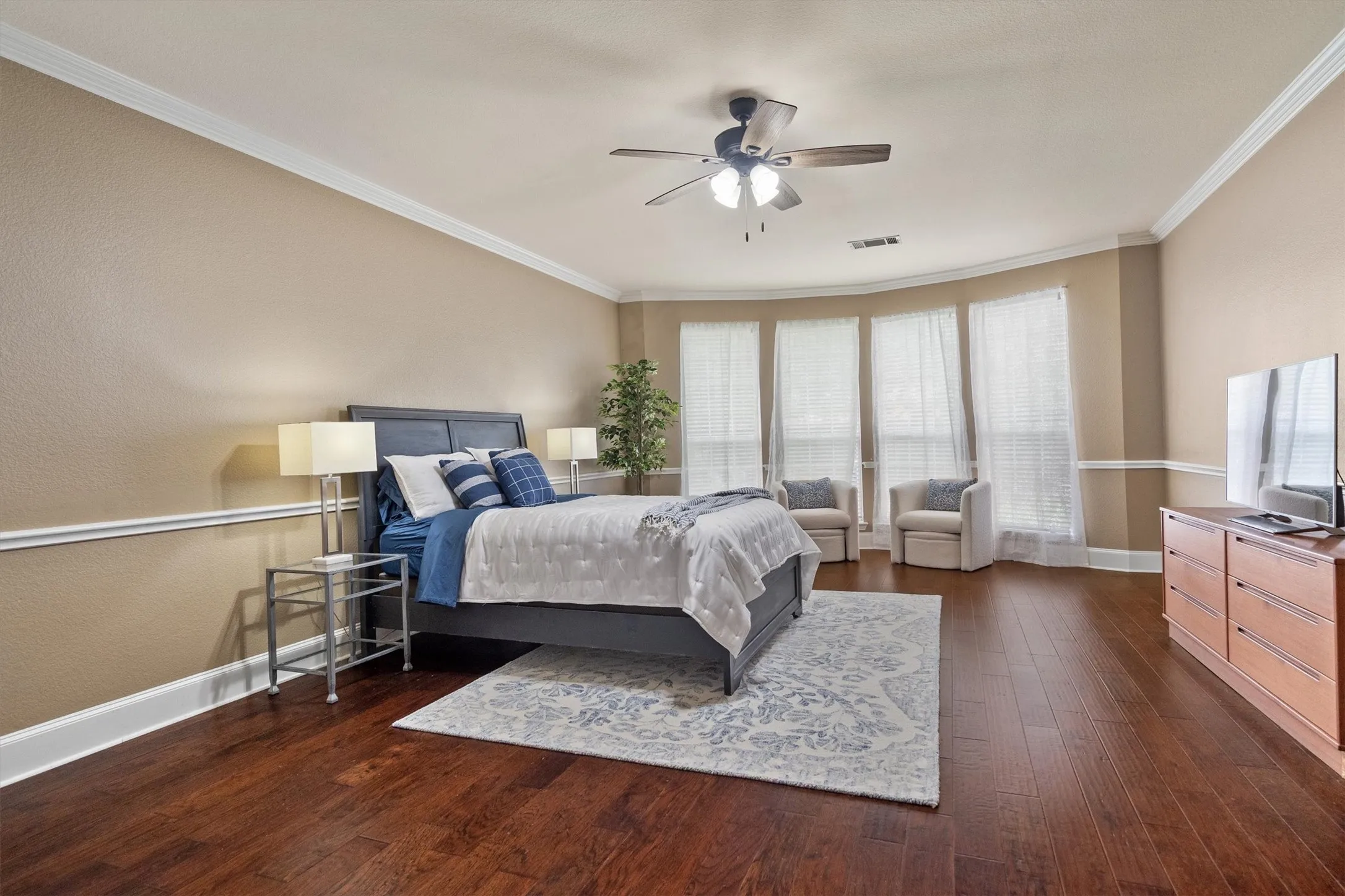 The Downstairs In-Law Quarters feature an oversized bedroom with sitting area + an ensuite bath.
