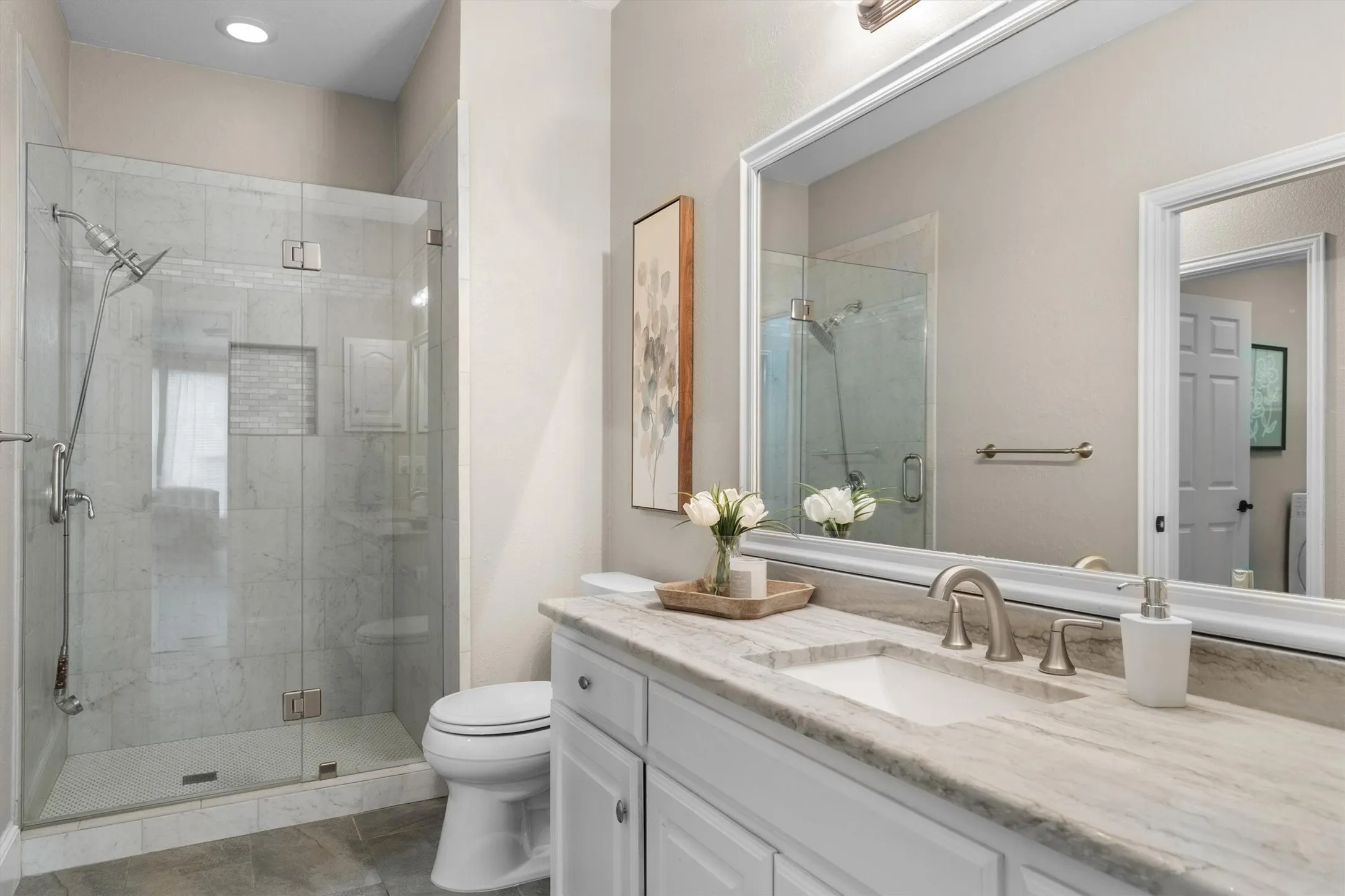 The ensuite bath also opens to the hallway downstairs.