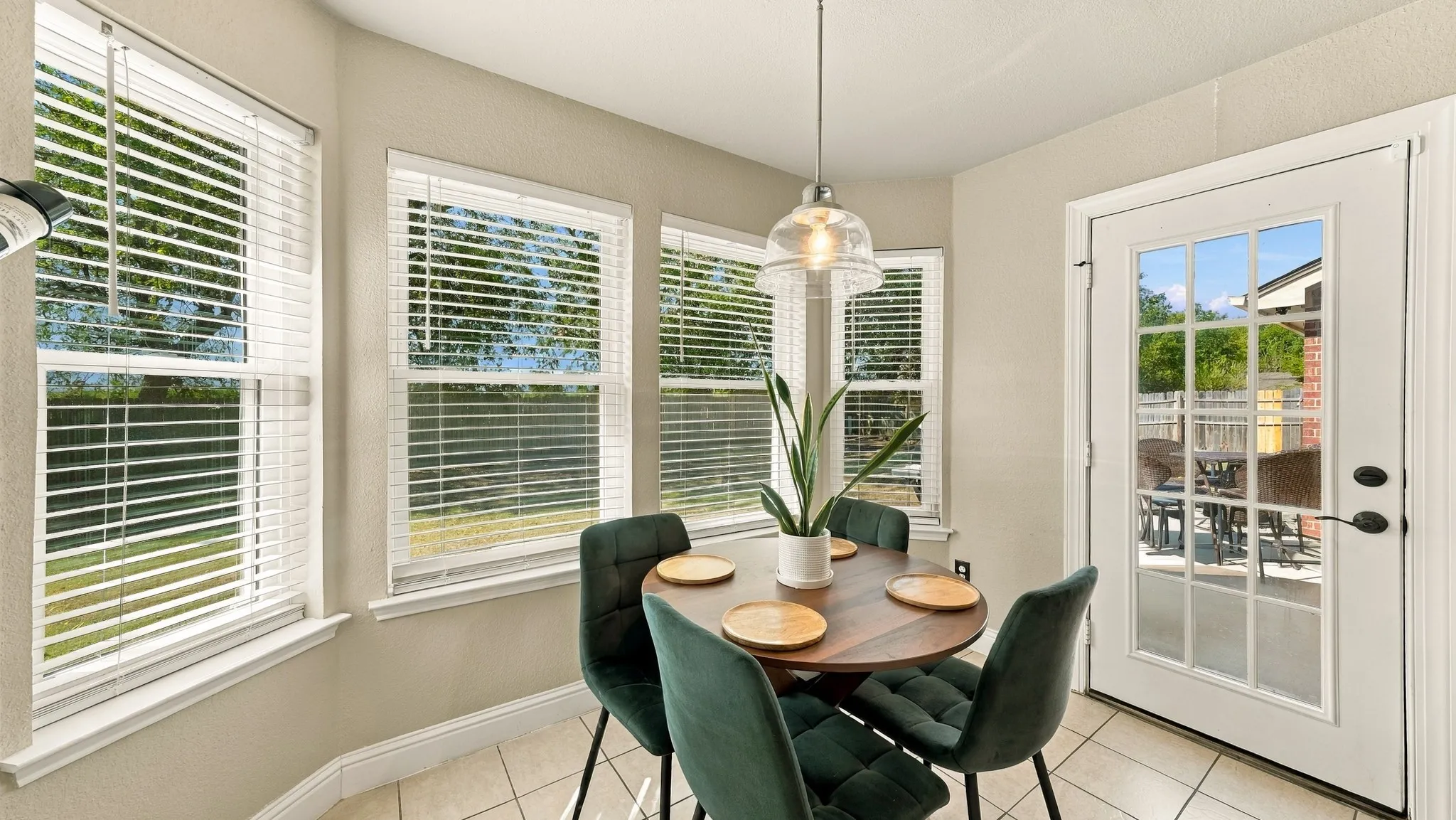 Bay window with multiple windows, recessed ceiling lighting, tile flooring, and a white paneled door
