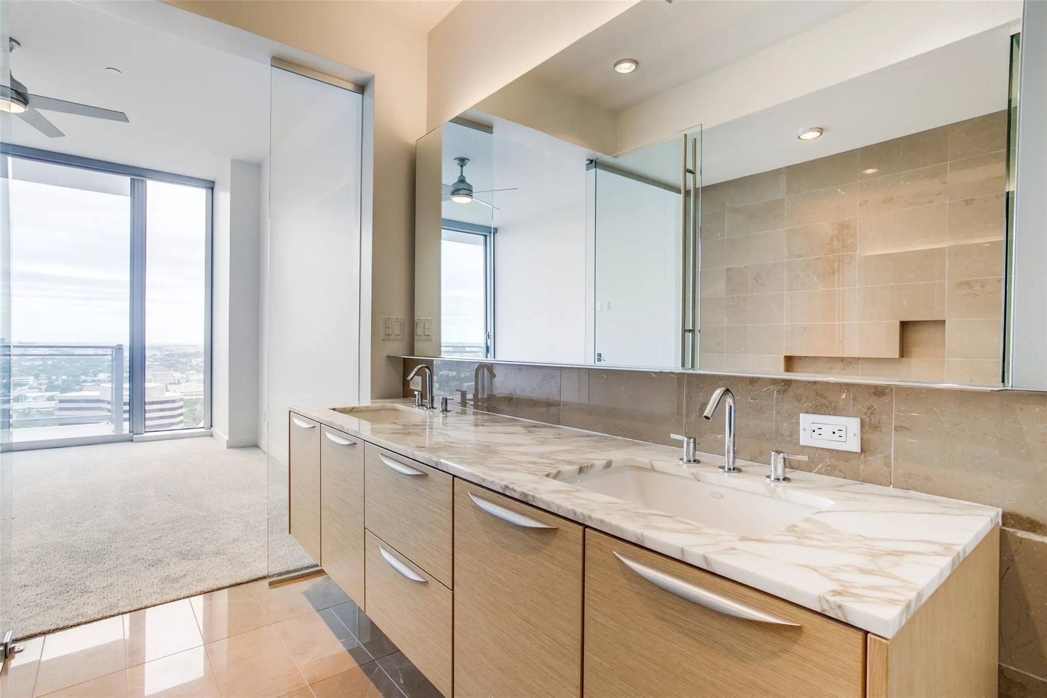 Dual vanity with stone countertop, under-mount sinks, and chrome fixtures