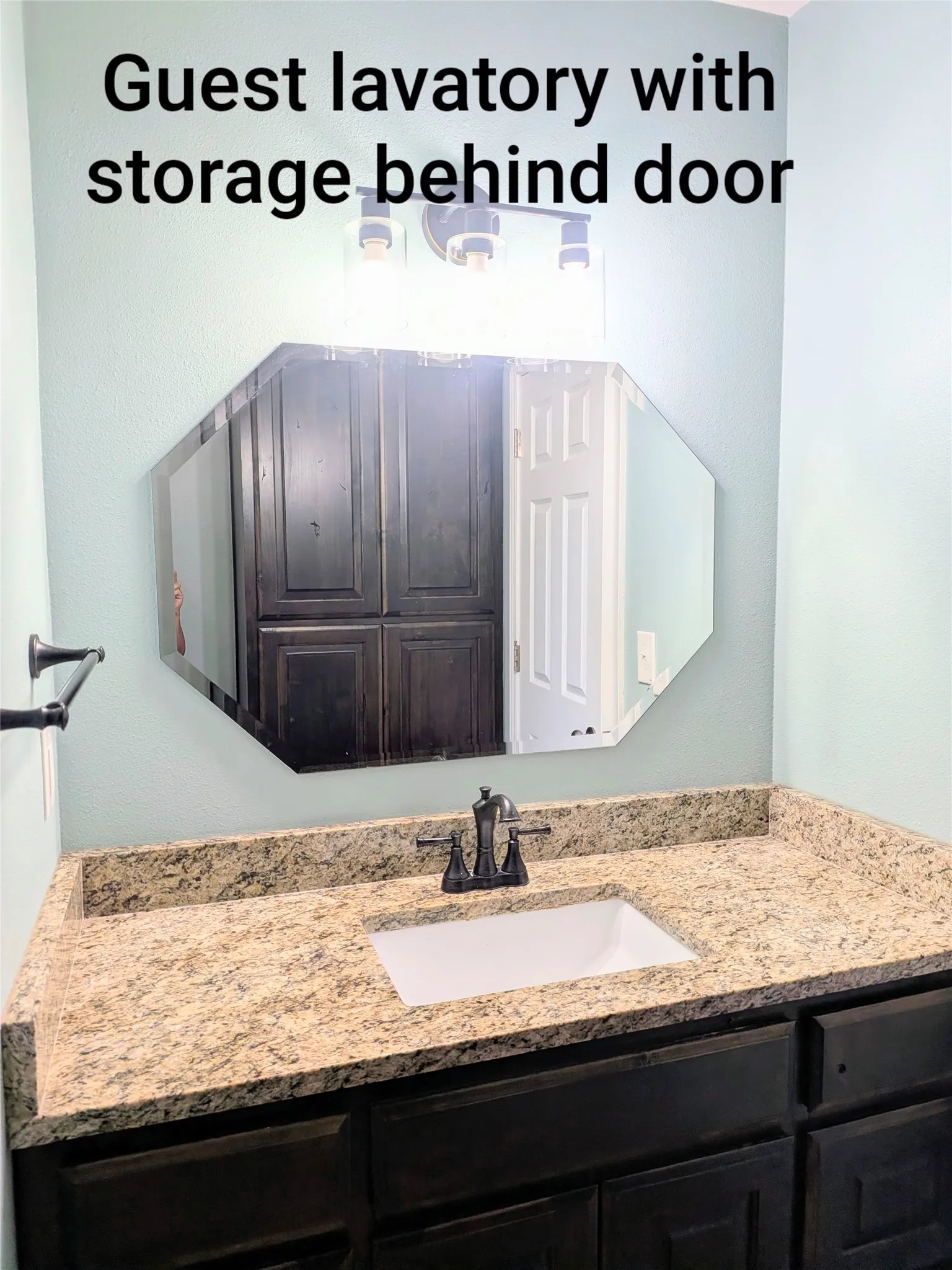 Guest bath showing linen storage in mirror