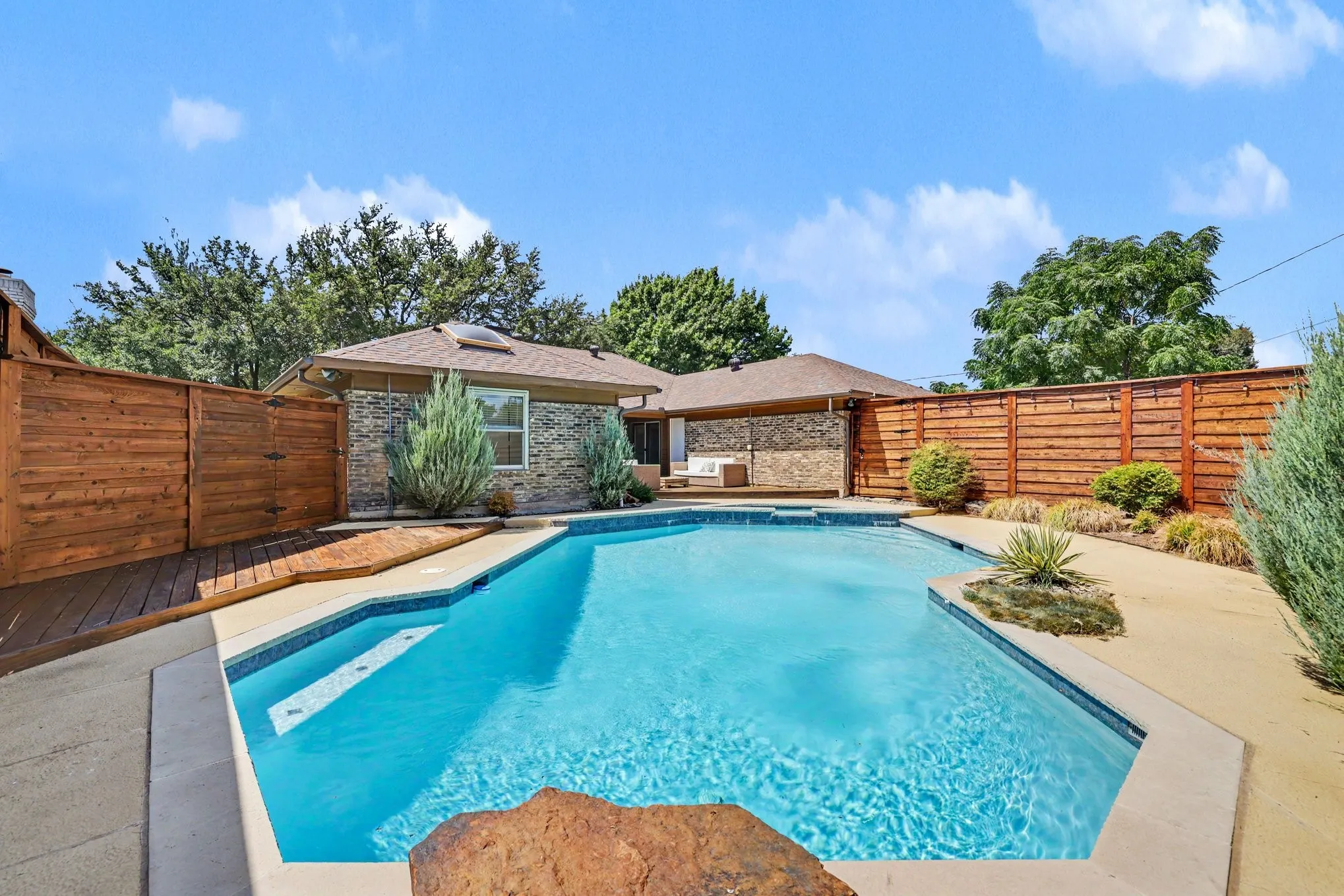 There is a fenced side yard to the left.