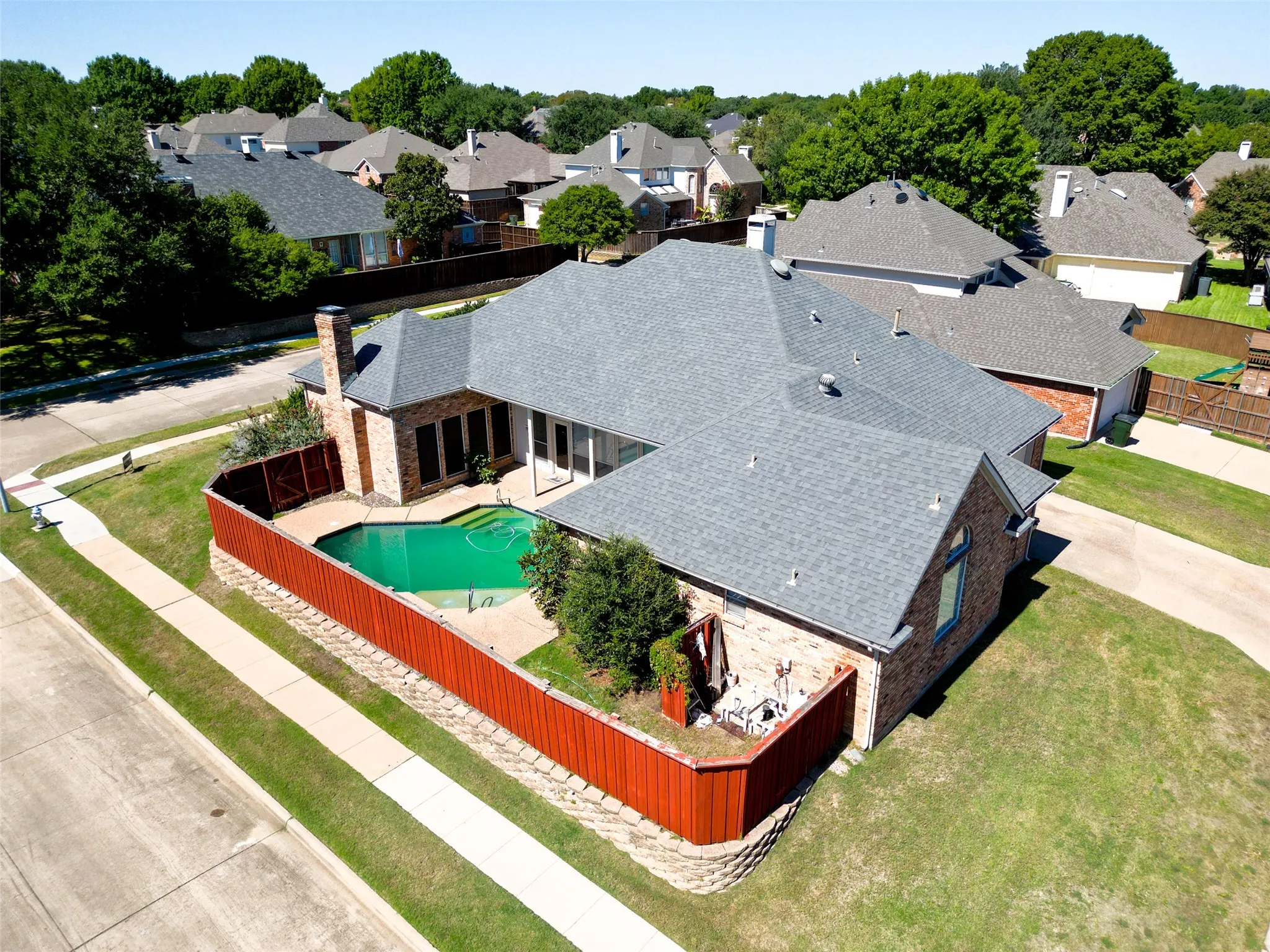 Brick exterior with a gray shingle roof