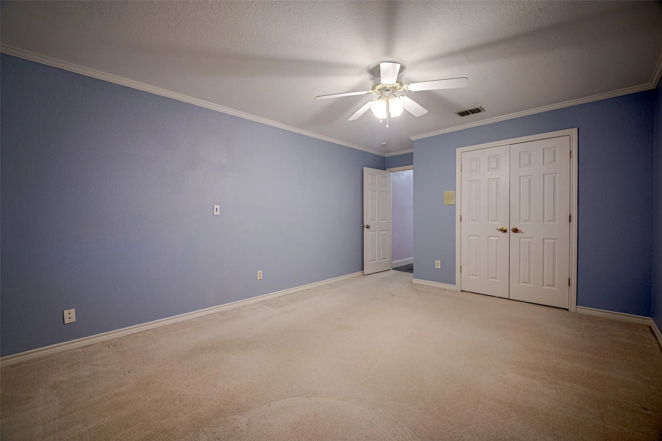 Neutral-toned carpeting with light blue walls