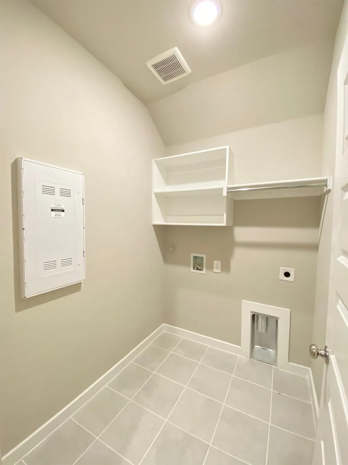 Tile flooring, built-in shelving, clothing rod, recessed lighting, and a white paneled door