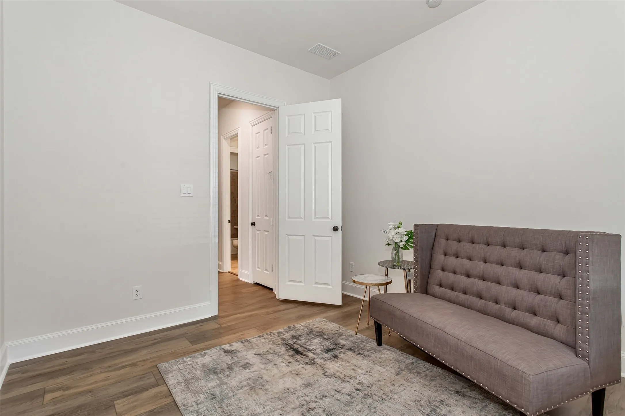 Wood-finish flooring with white baseboards