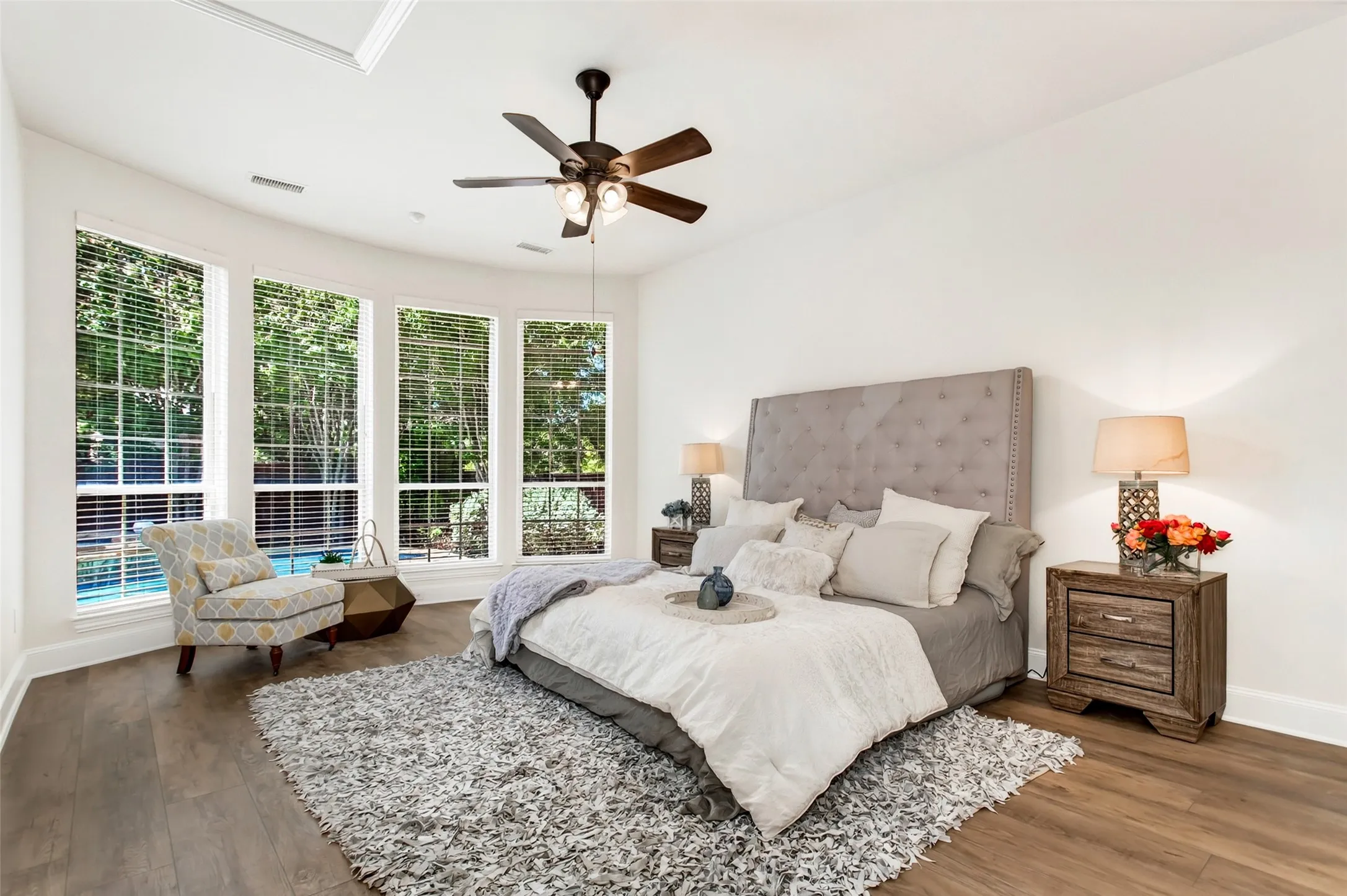Wood-finish flooring, recessed lighting, and a ceiling fan with integrated lighting