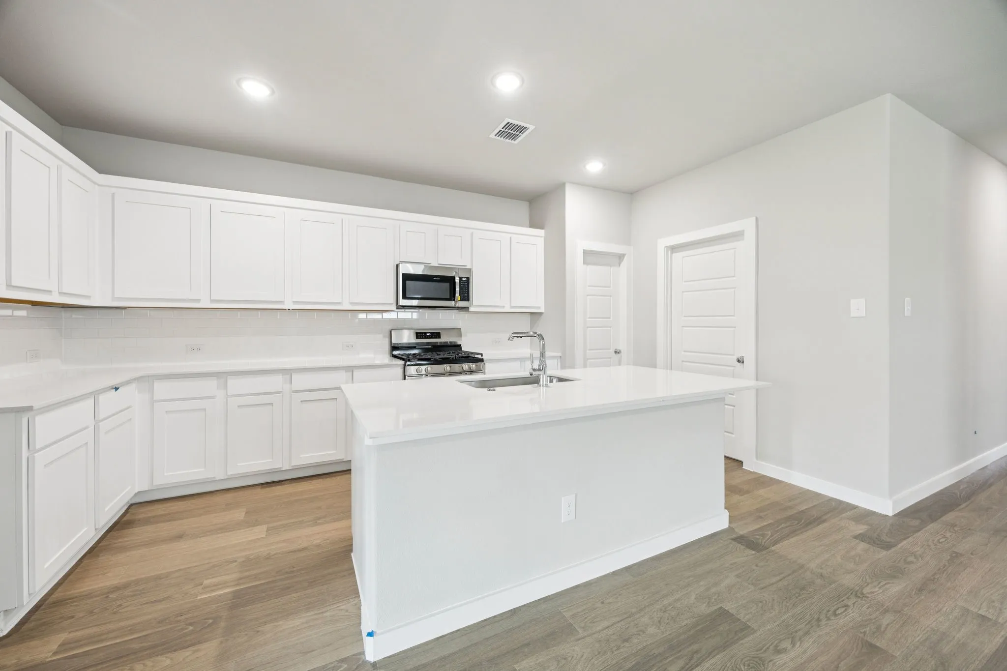 Kitchen in the Hayden home plan by Trophy Signature Homes – REPRESENTATIVE PHOTO
