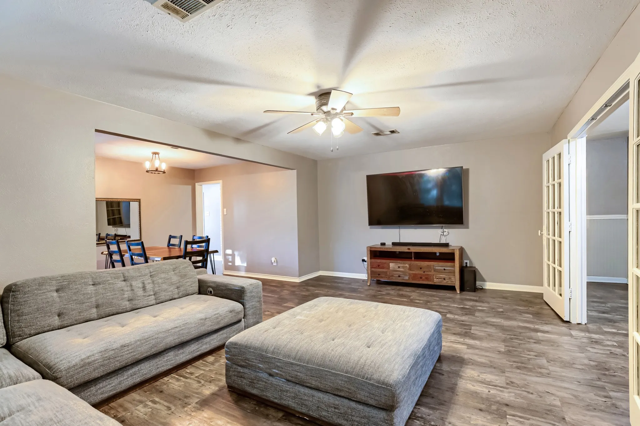 Wood-finish flooring, ceiling fan, and French doors