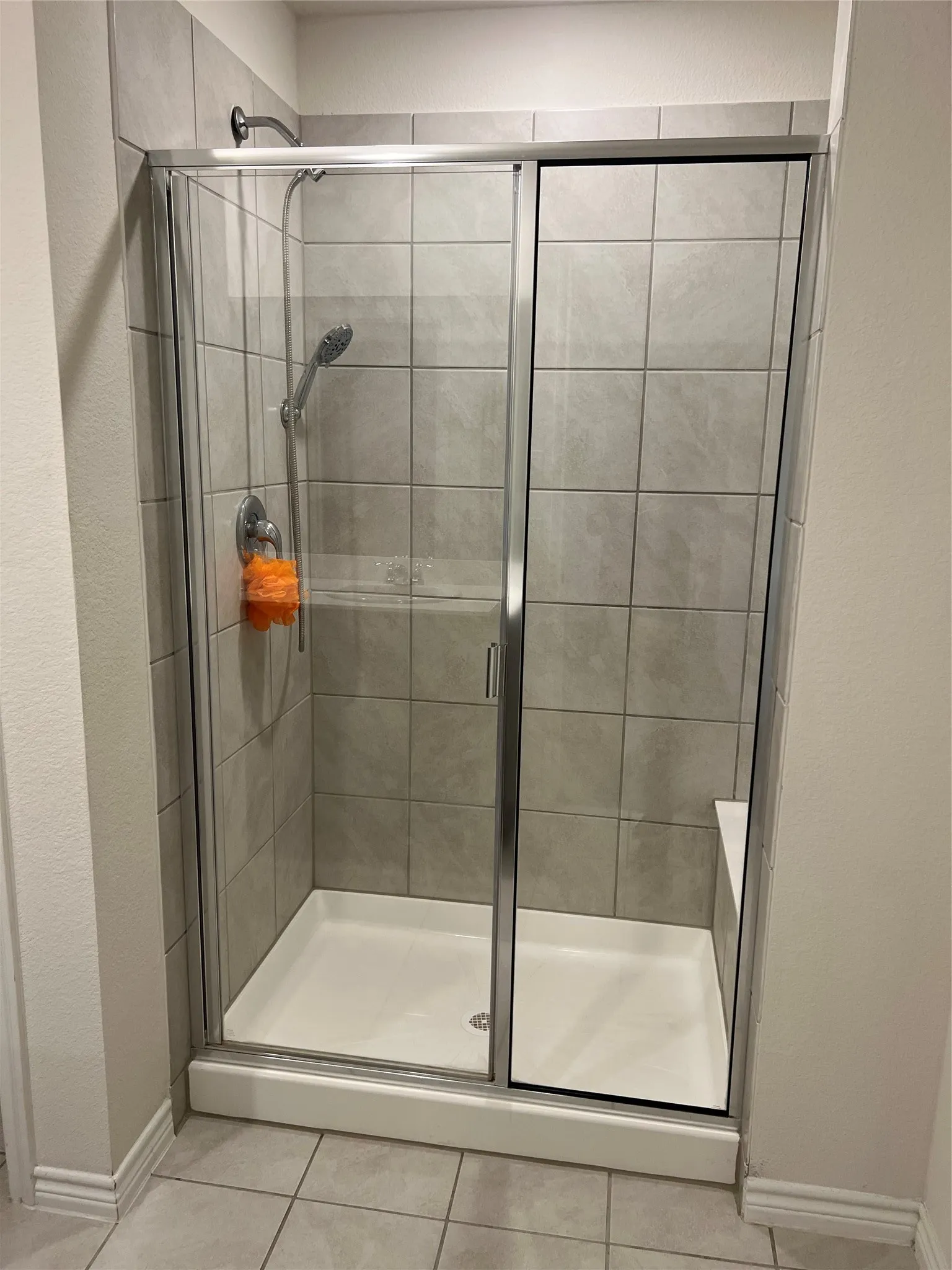 Bathroom with tile floors and a shower with door